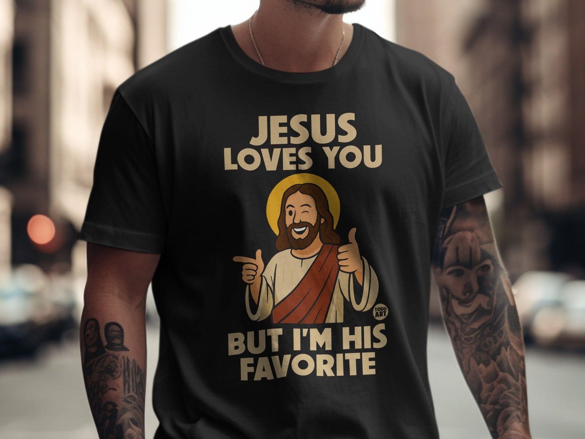 Jesus Loves You But I'm His Favorite t-shirt with cartoon Jesus giving thumbs up.
