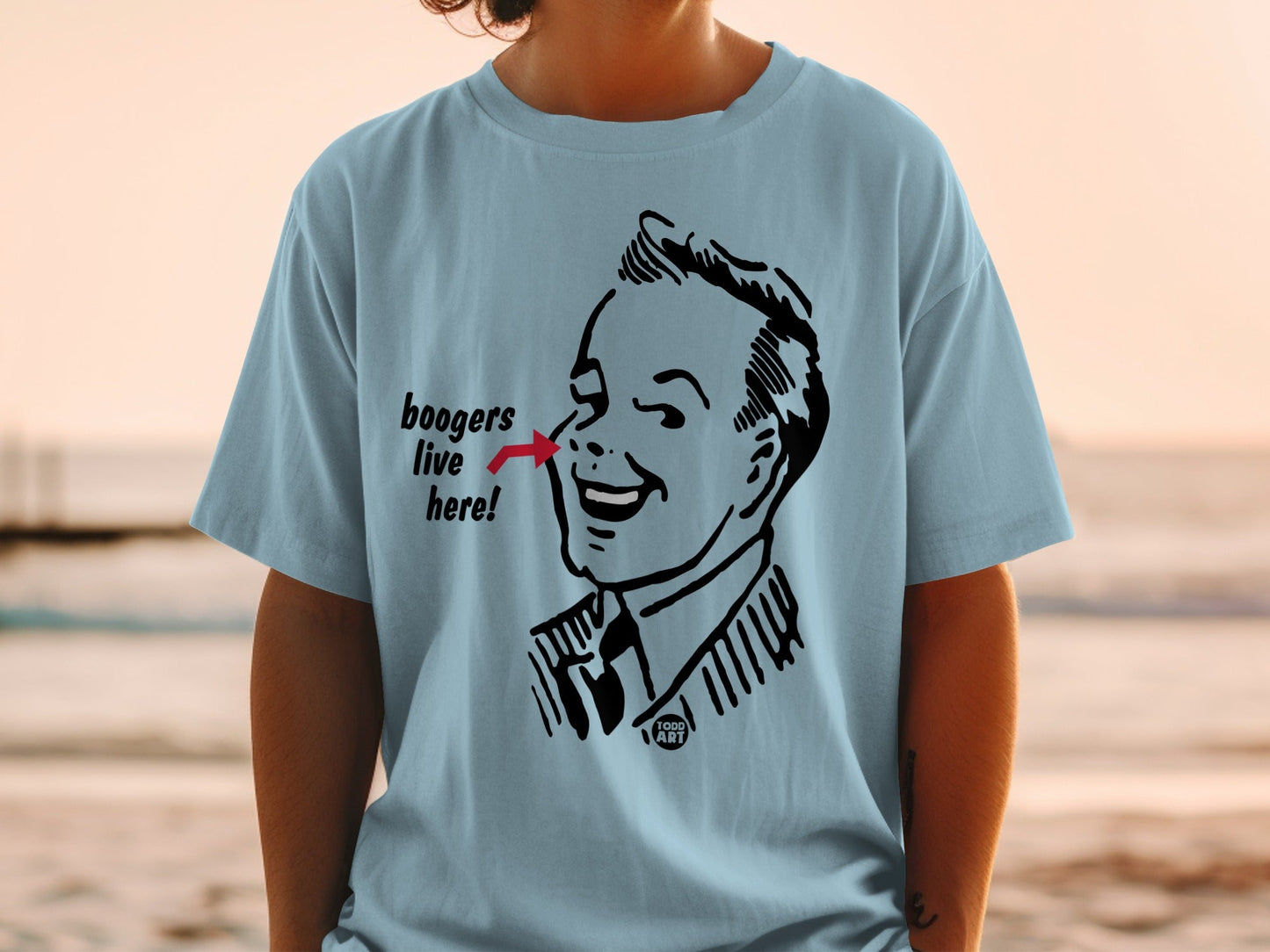 Light blue t-shirt featuring a vintage comic illustration of a man with "boogers live here!" text.