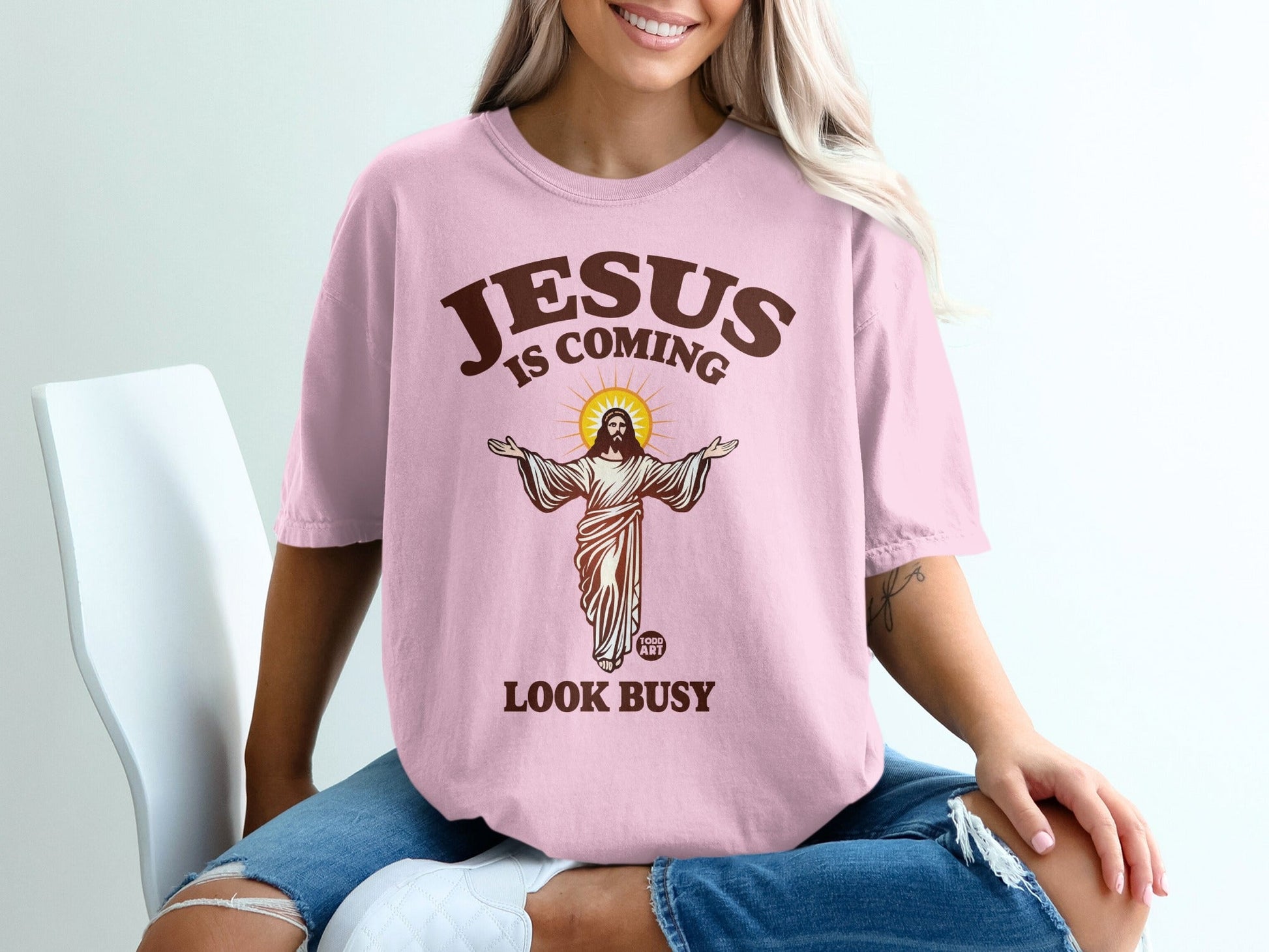 Jesus is coming, look busy graphic on pink t-shirt.