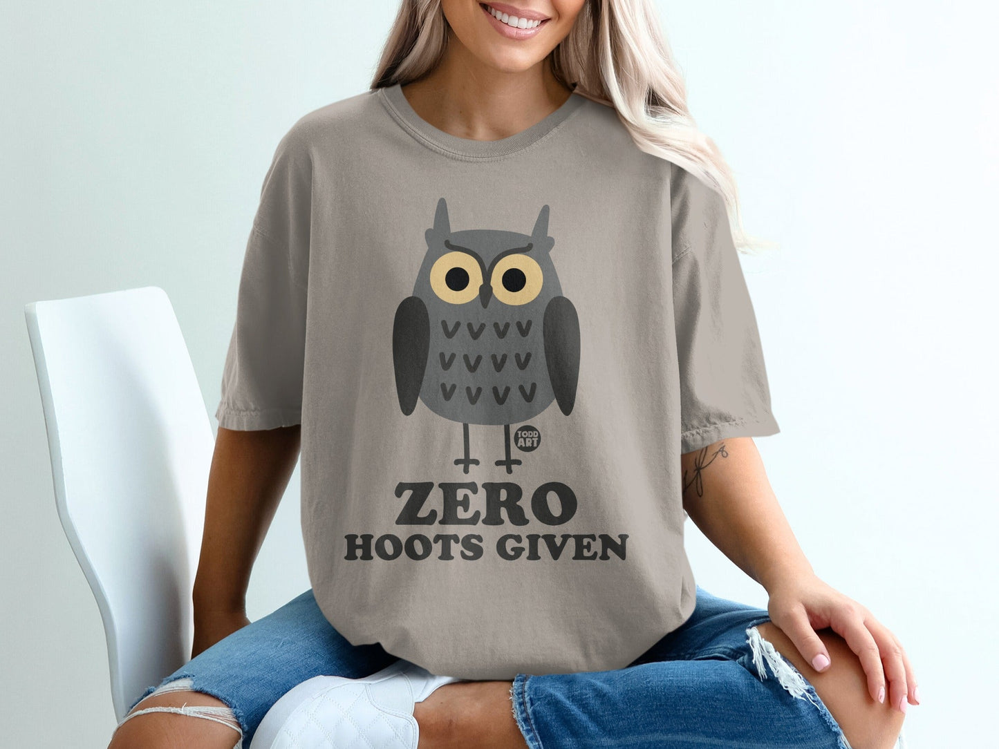 Grey t-shirt with a cartoon owl and text "ZERO HOOTS GIVEN".