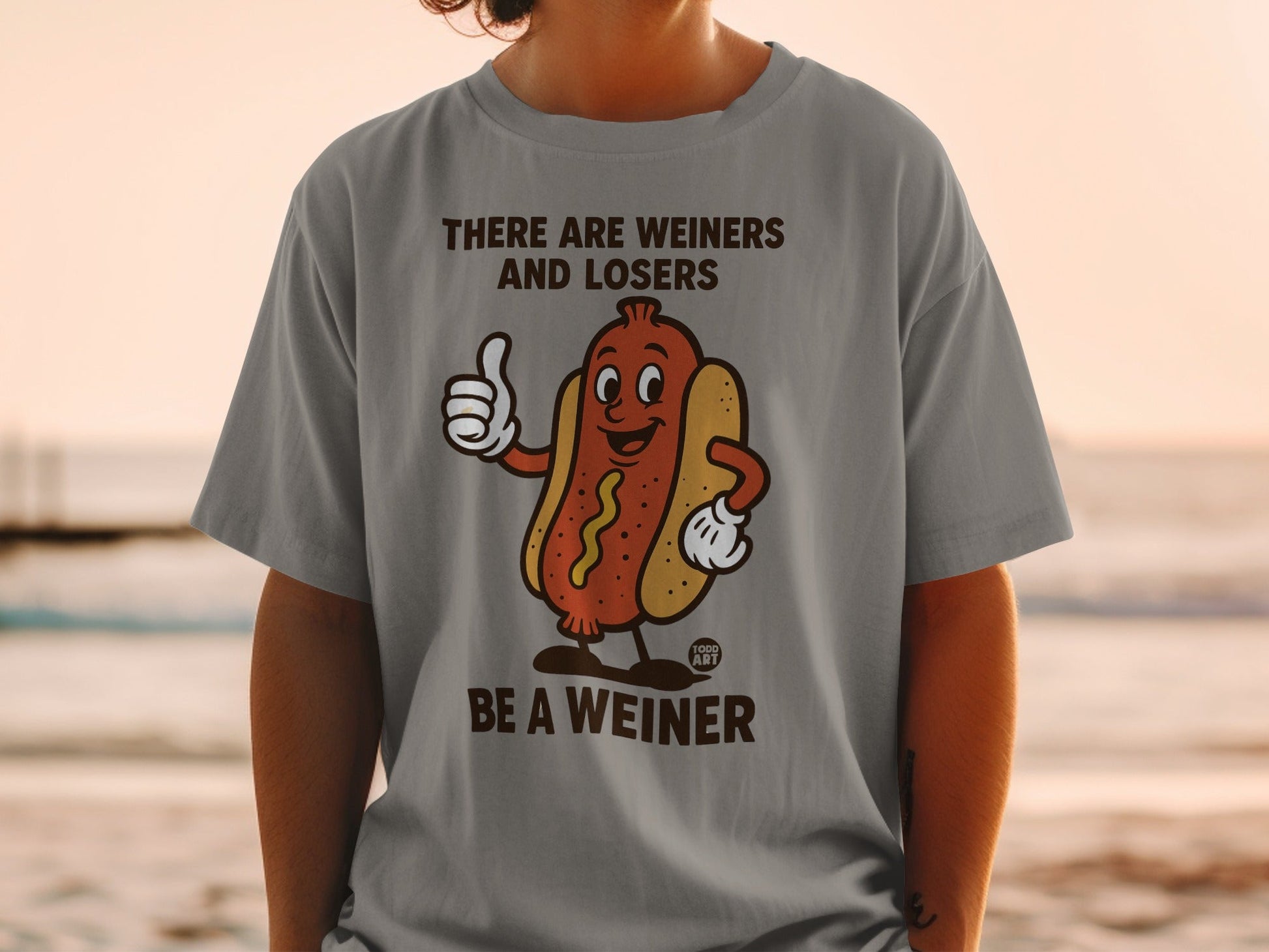 Grey t-shirt with cartoon hot dog giving a thumbs up, saying "THERE ARE WEINERS AND LOSERS BE A WEINER."