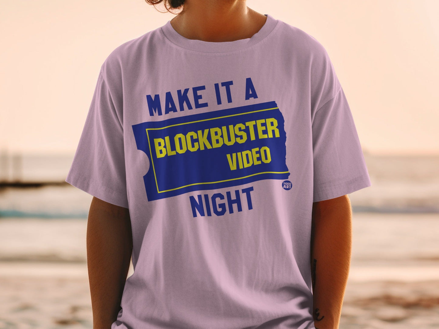 Purple t-shirt with "Make it a Blockbuster Night" text and logo.