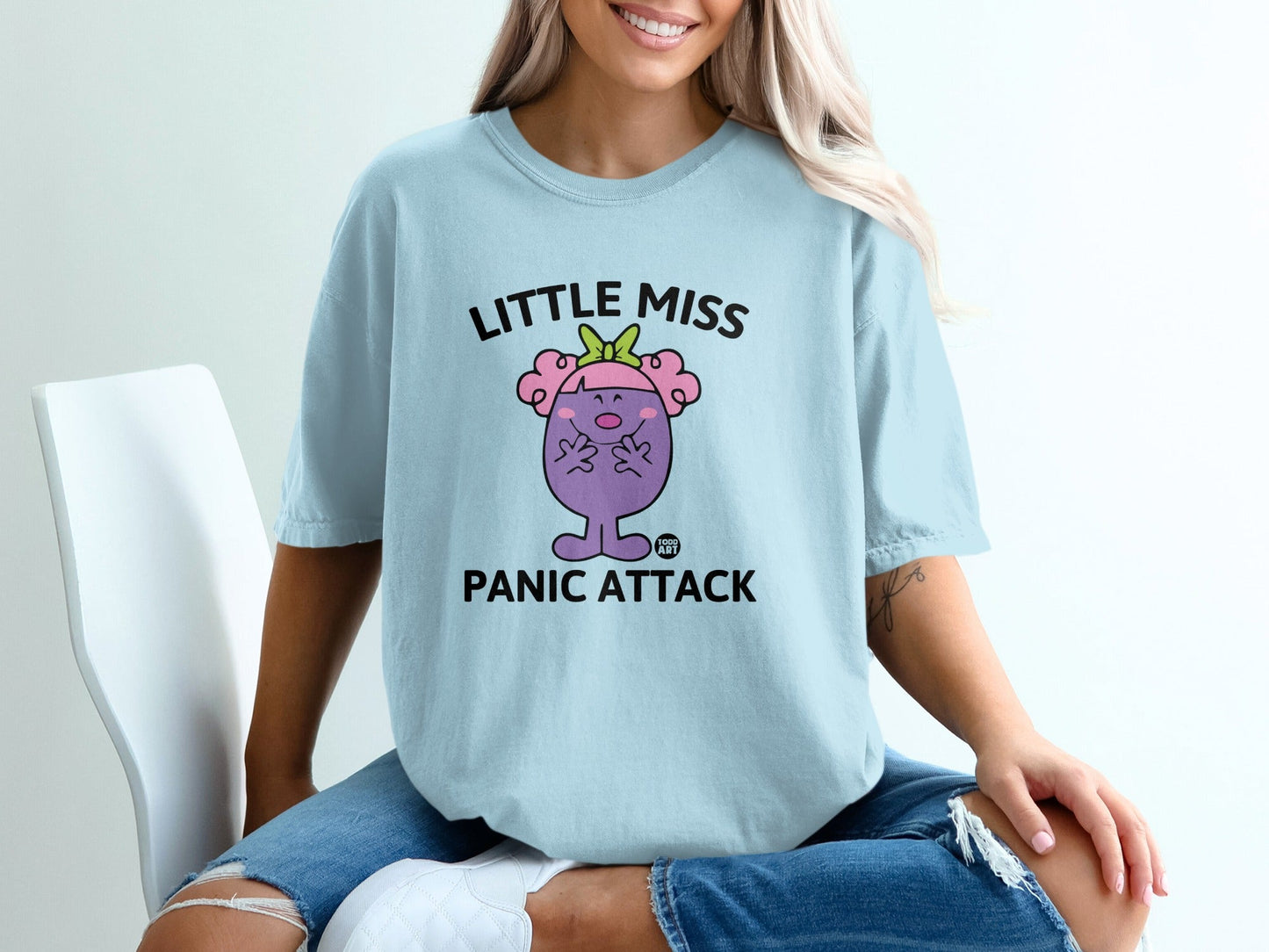 Light blue t-shirt with "Little Miss Panic Attack" text and cartoon character.