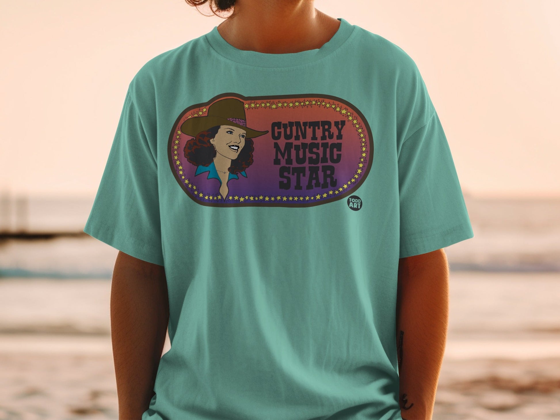 T-shirt with oval graphic featuring a woman and "Country Music Star" text.