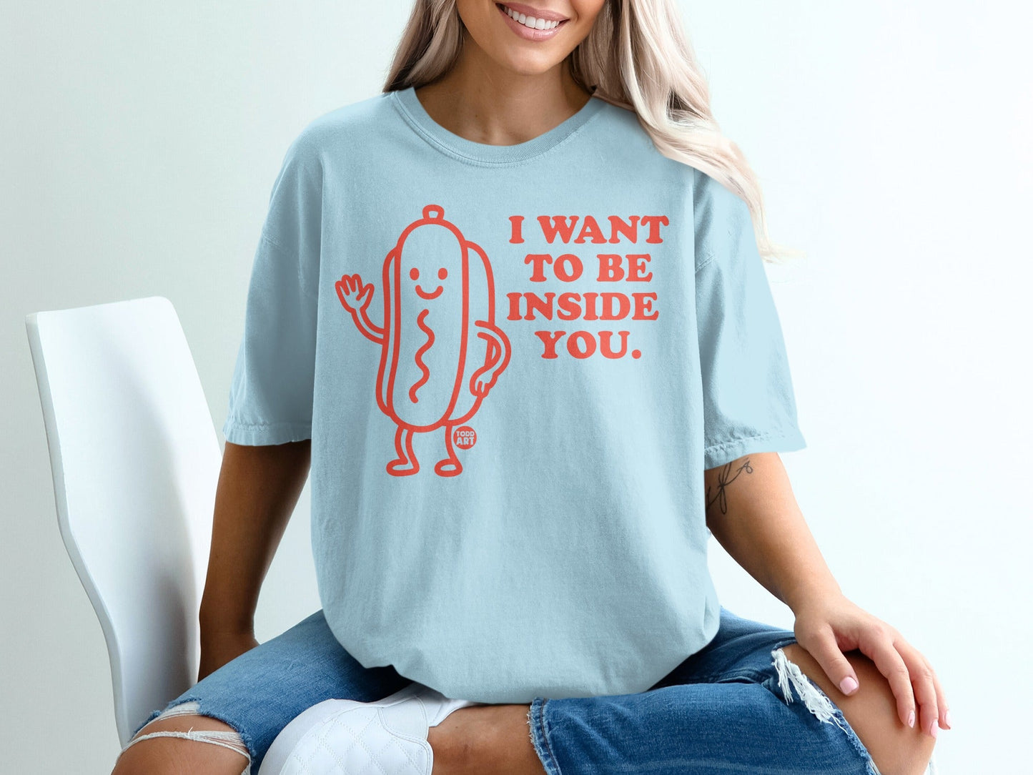 Light blue t-shirt with a cartoon hot dog and text "I WANT TO BE INSIDE YOU."