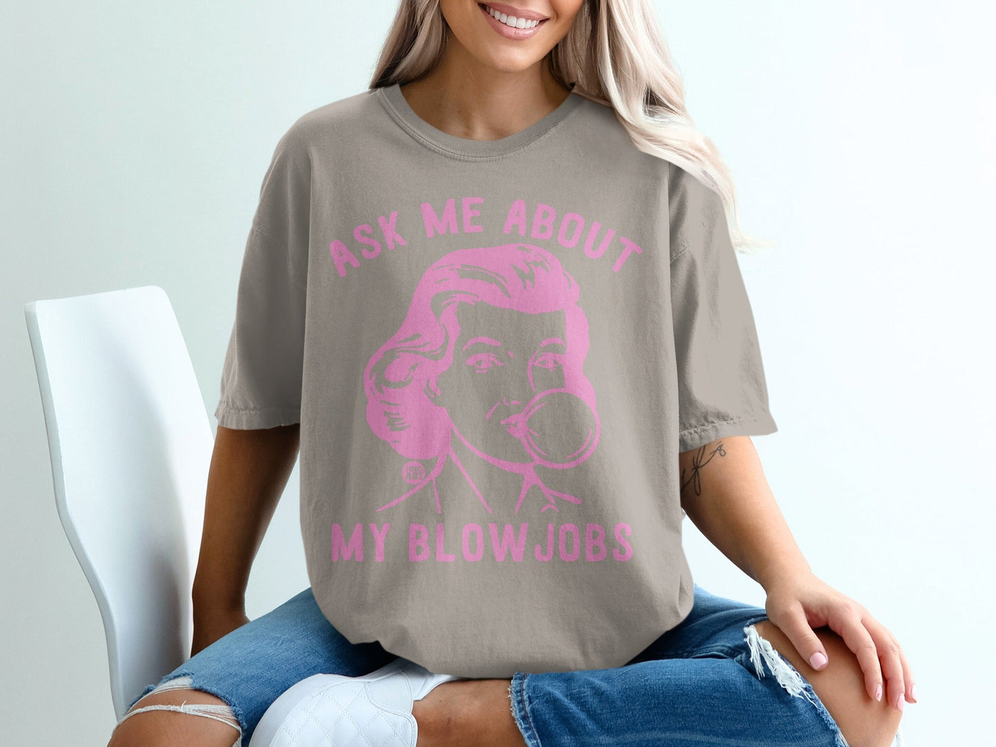 T-shirt with text "ASK ME ABOUT MY BLOWJOBS" in pink graphic.