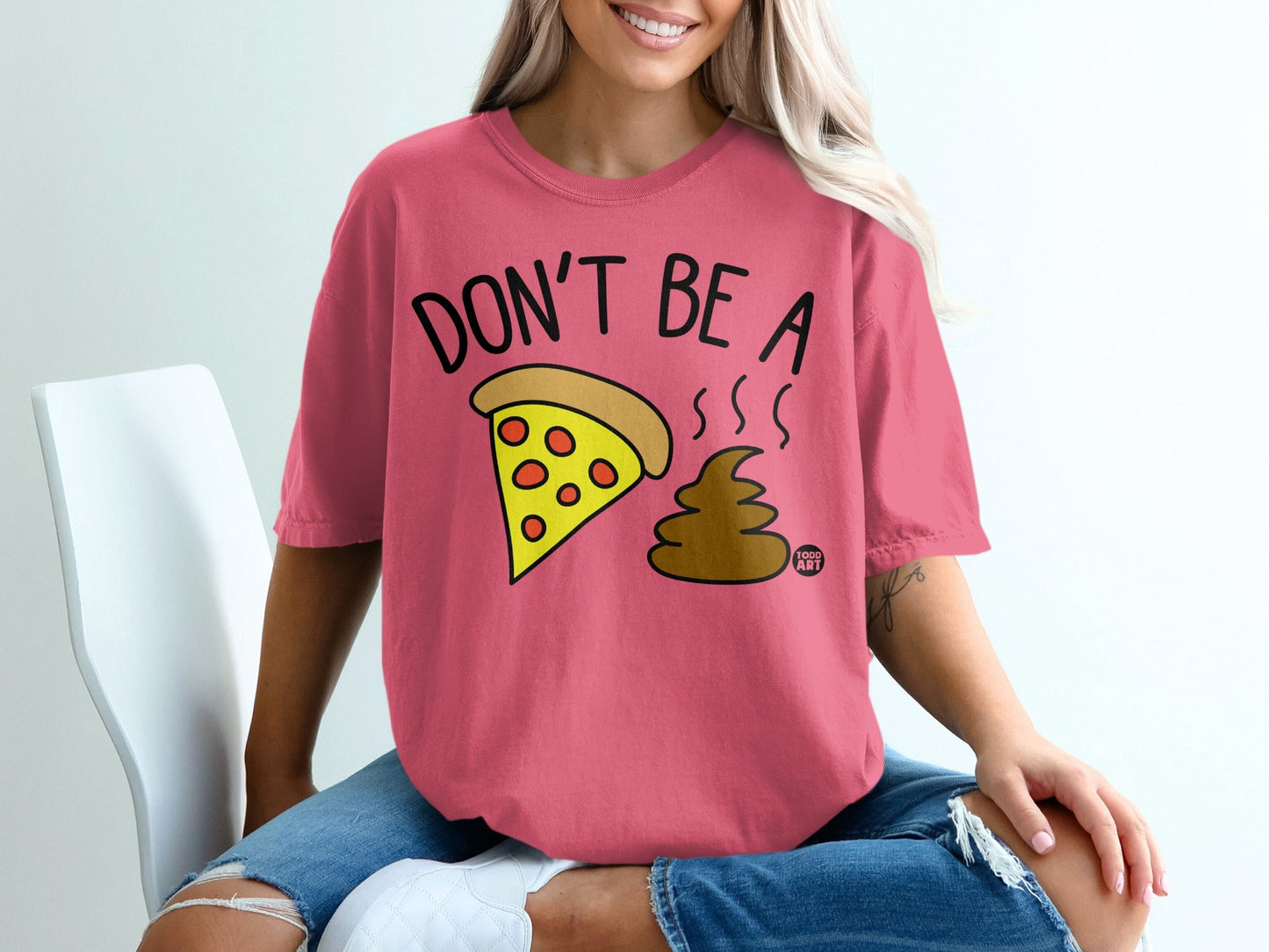 Pink t-shirt with "Don't be a poo" graphic and pizza slice.