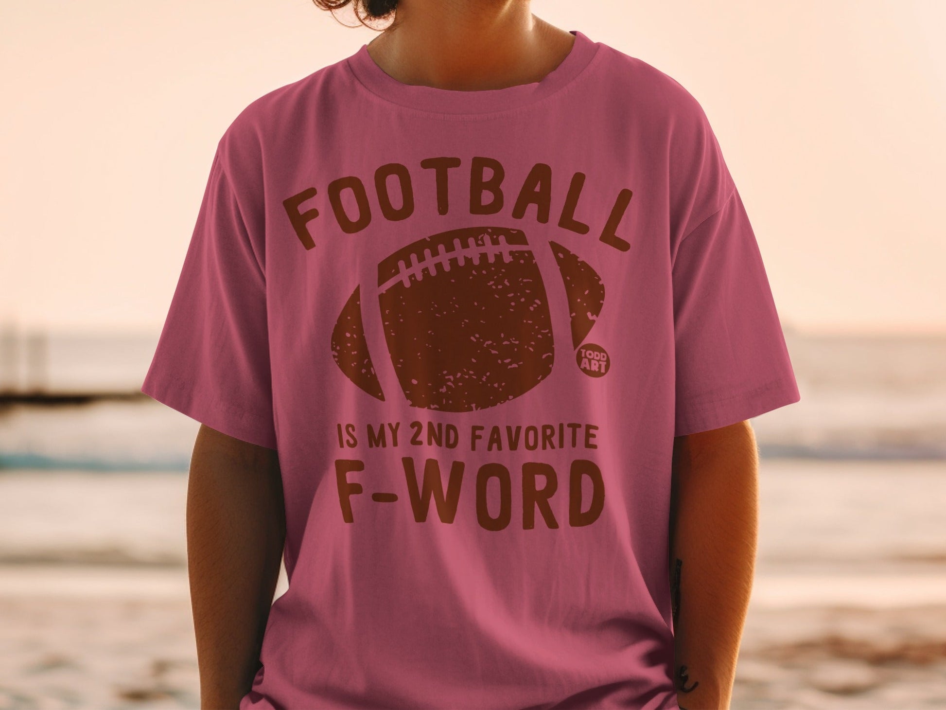 Pink t-shirt with "FOOTBALL IS MY 2ND FAVORITE F-WORD" and football graphic.