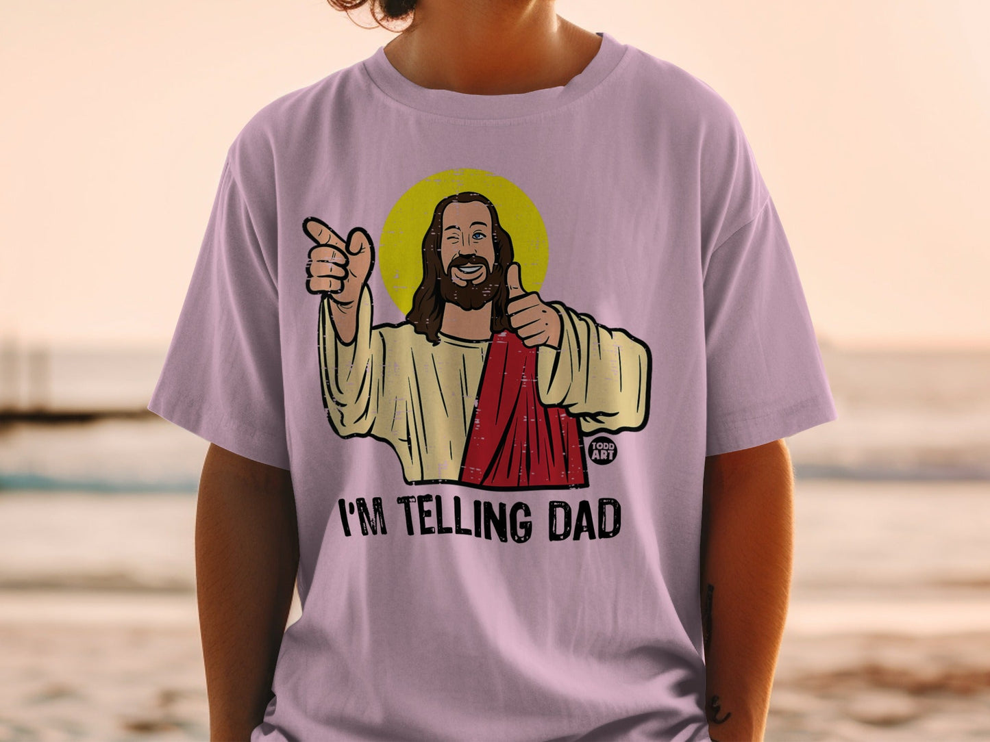 Purple t-shirt with Jesus graphic pointing and giving thumbs up, text "I'M TELLING DAD".