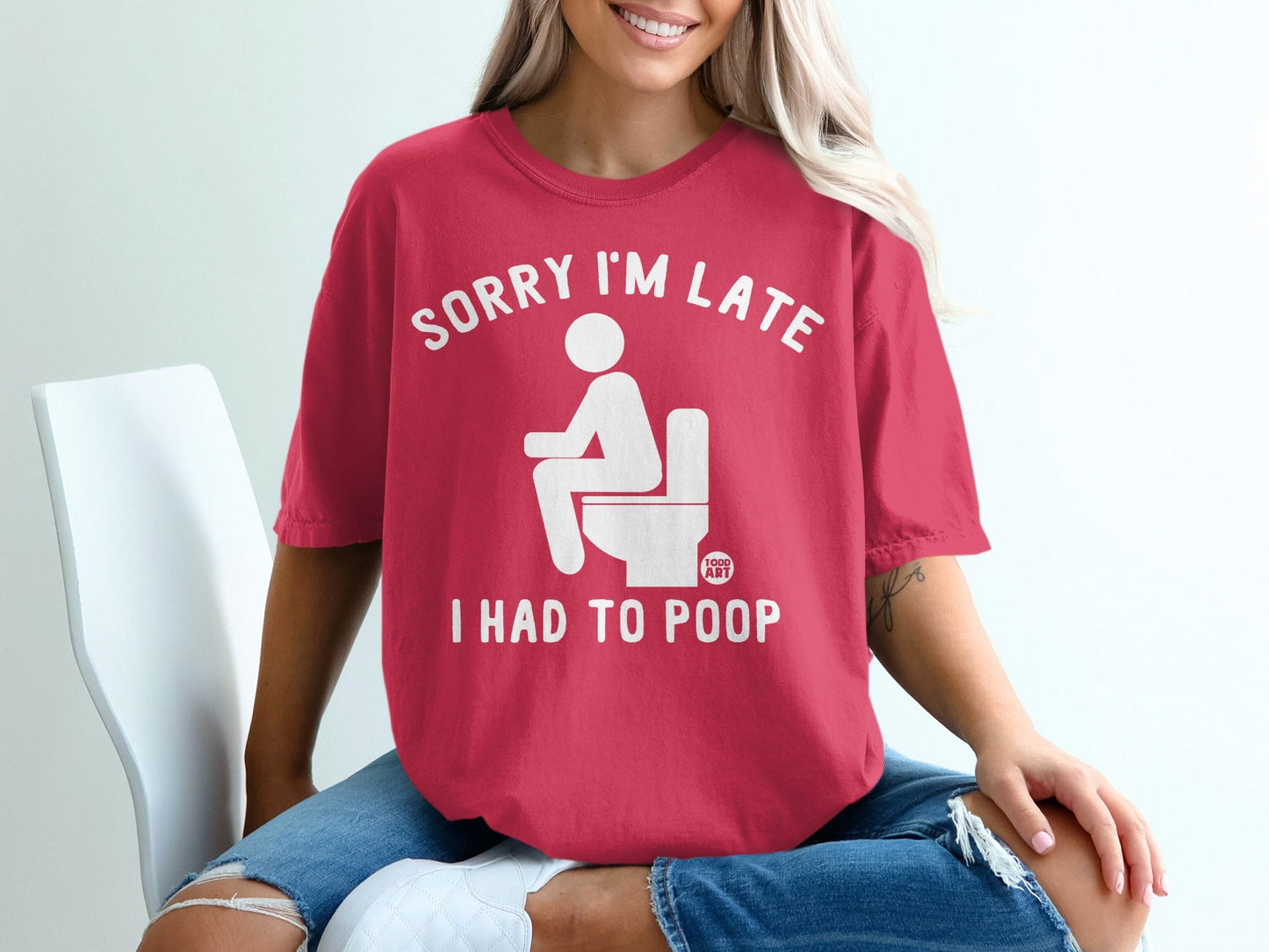 Red t-shirt with white text and graphic: "SORRY I'M LATE I HAD TO POOP".