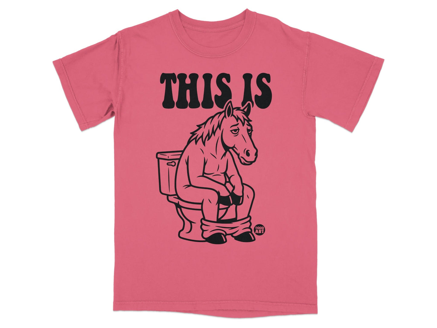T-shirt with "THIS IS" text and a drawing of a horse sitting on a toilet.