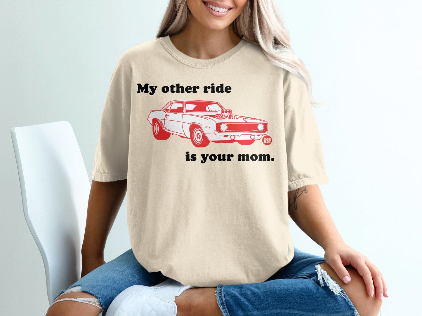 Cream t-shirt with red text "My other ride is your mom." and a red car graphic.