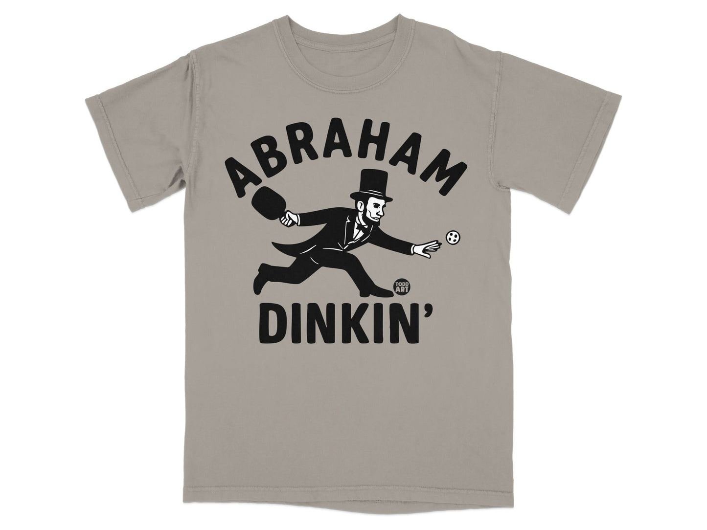 Abraham Lincoln in a top hat playing pickleball on a grey t-shirt.