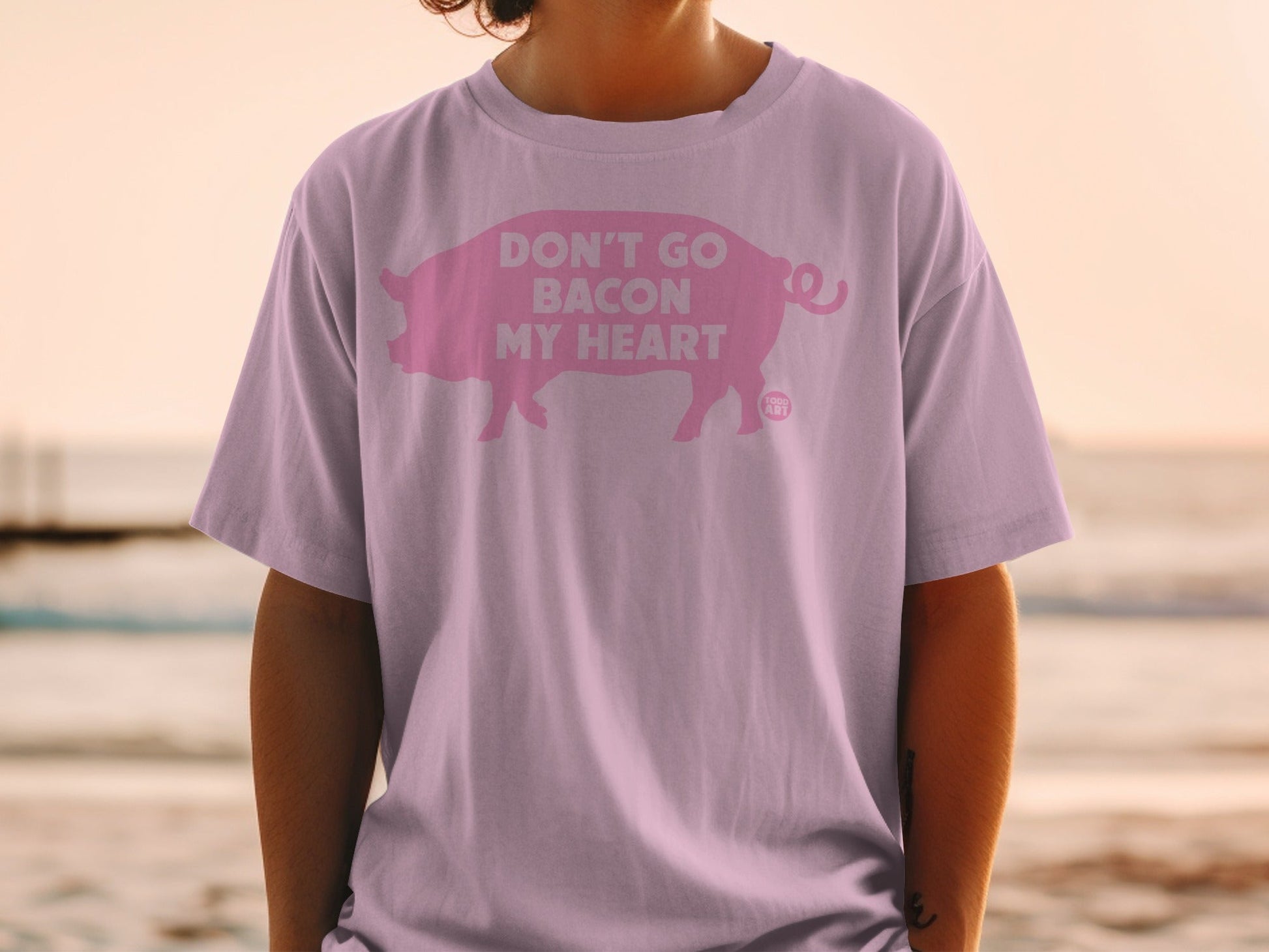 Pink t-shirt with a pig graphic and "Don't go bacon my heart" text.