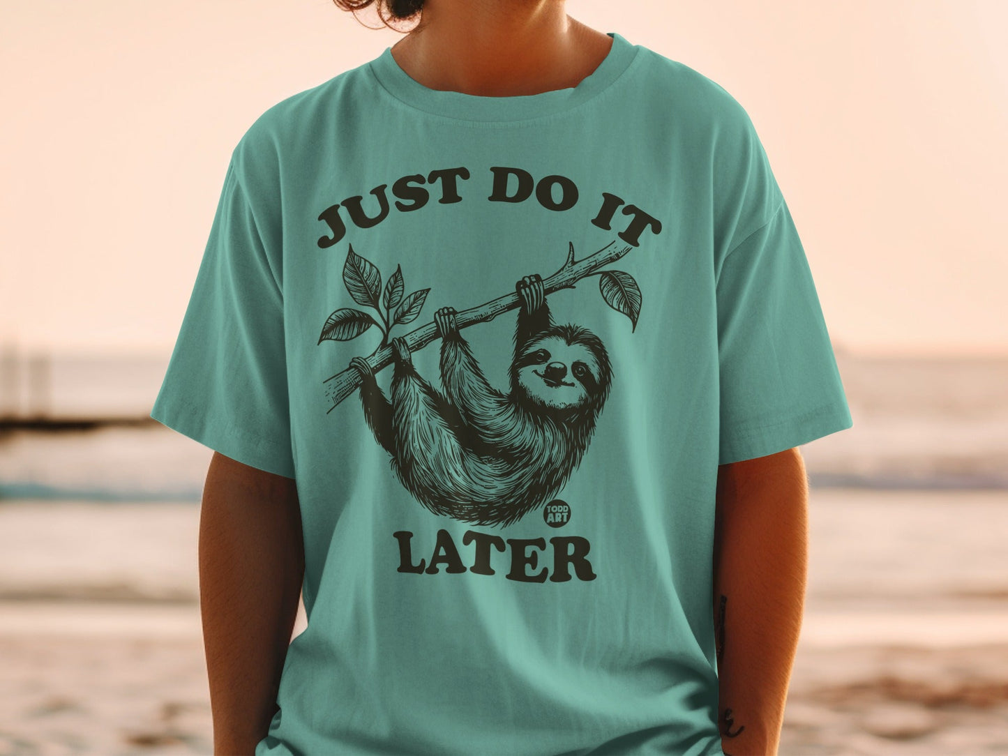 T-shirt with a sloth hanging from a branch and the text "JUST DO IT LATER".