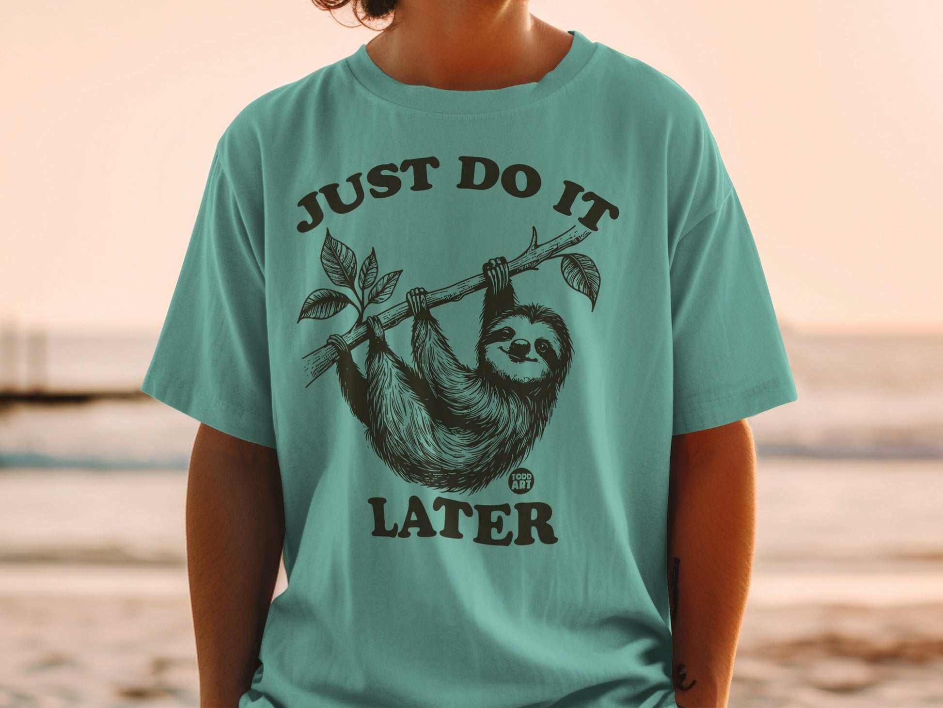 T-shirt with a sloth hanging from a branch and the text "JUST DO IT LATER".