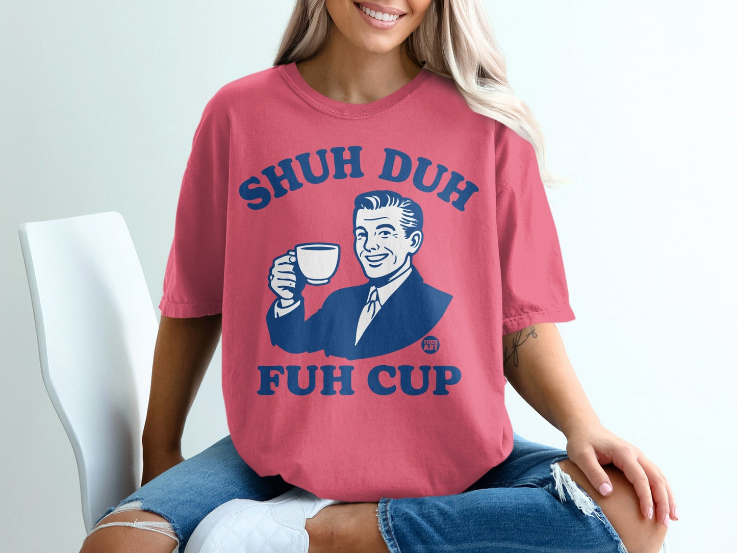 Pink t-shirt with "Shuh Duh Fuh Cup" and a retro man holding a coffee cup.