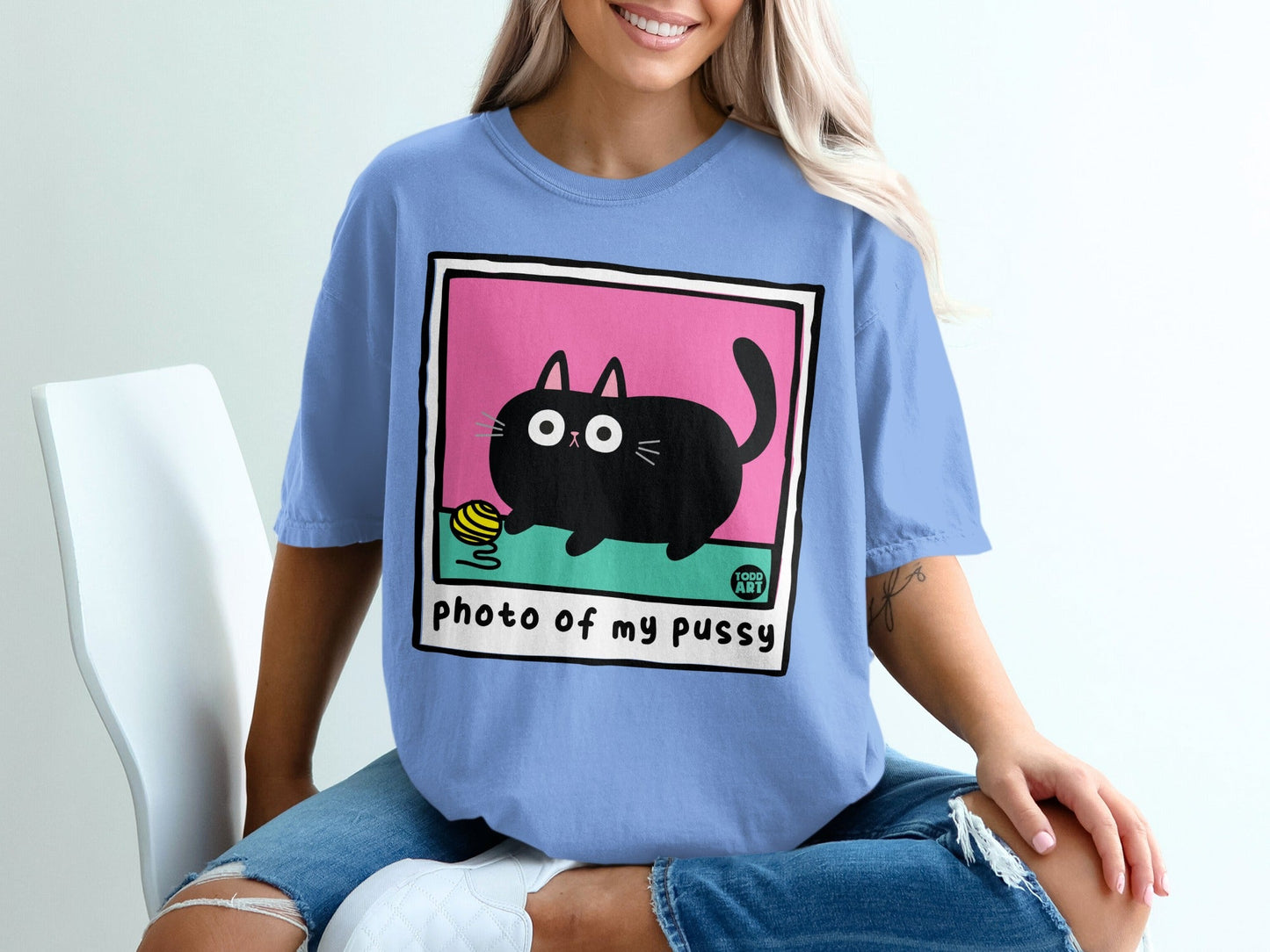 Black cartoon cat with yarn, text "photo of my pussy".