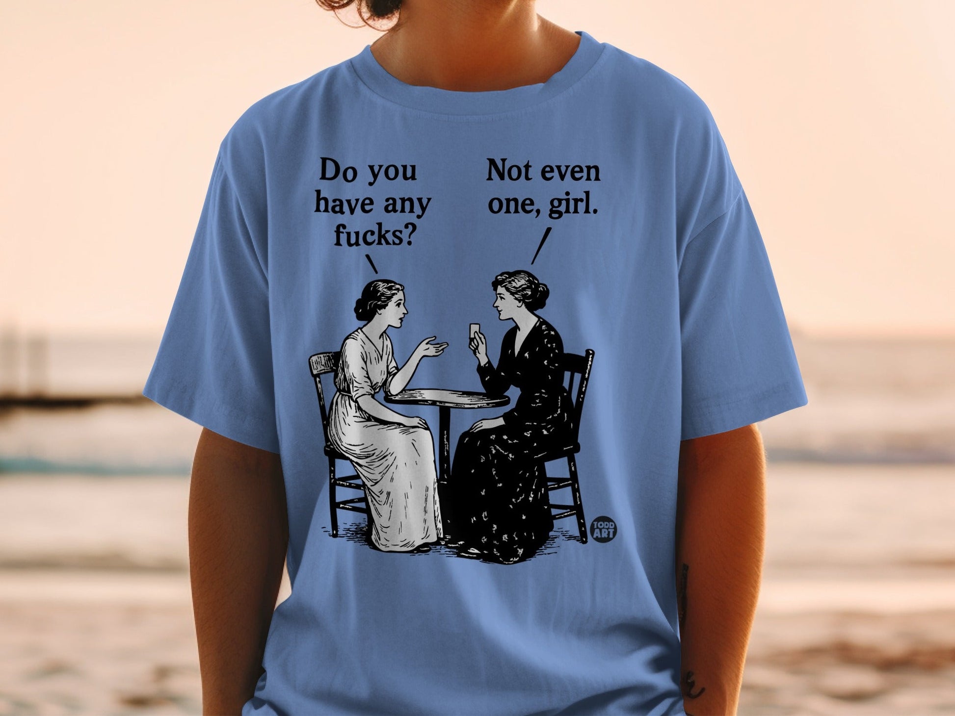 Two women sit at a table, one asking "Do you have any fucks?"