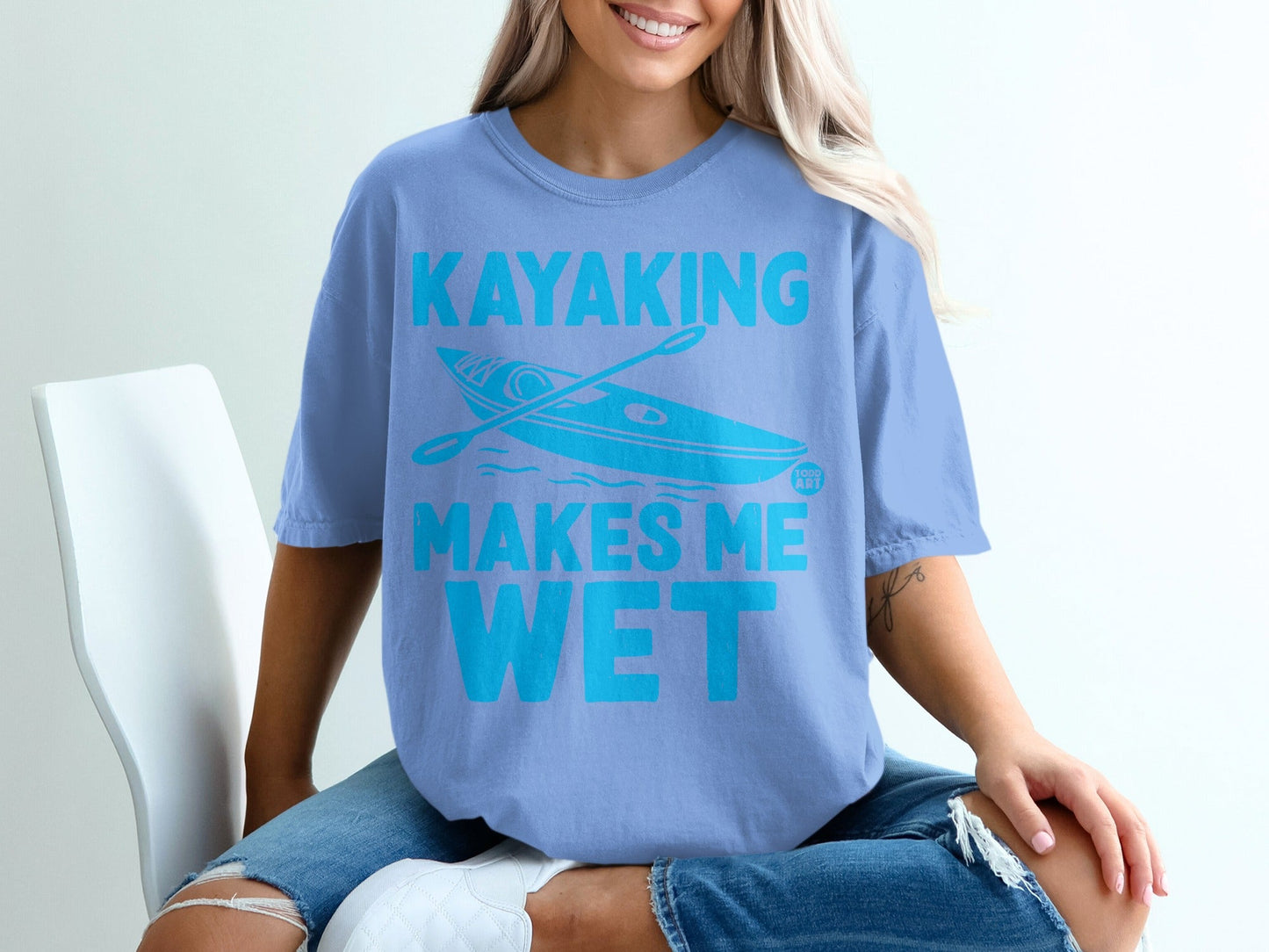 Blue t-shirt with "KAYAKING MAKES ME WET" and a kayak graphic.