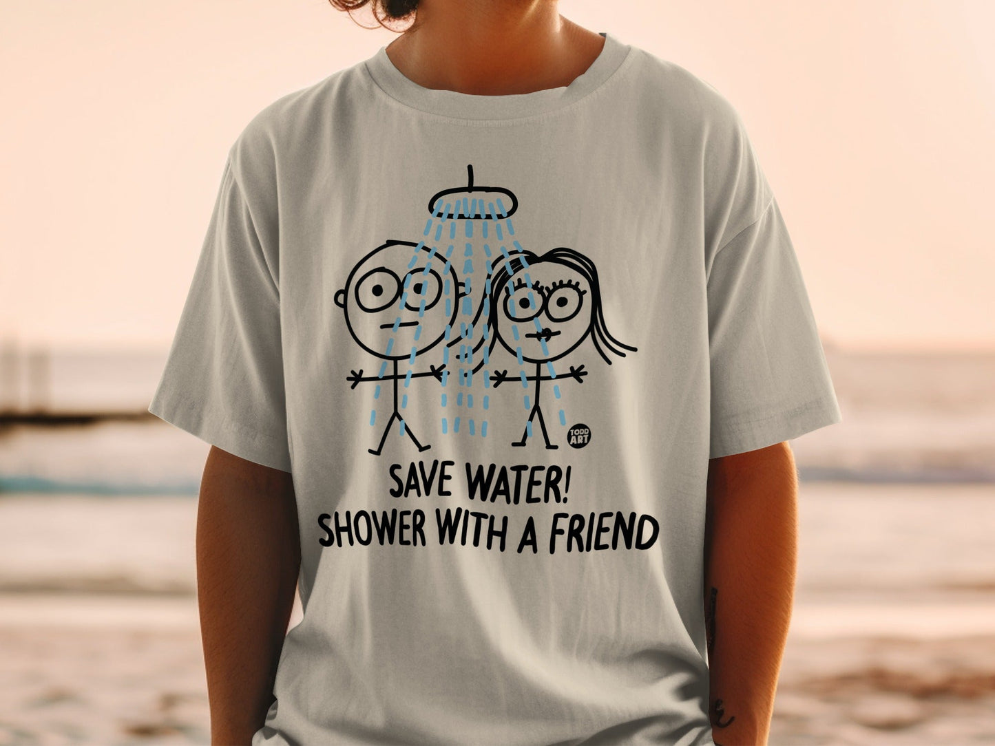 White t-shirt with cartoon couple showering, text "SAVE WATER! SHOWER WITH A FRIEND".