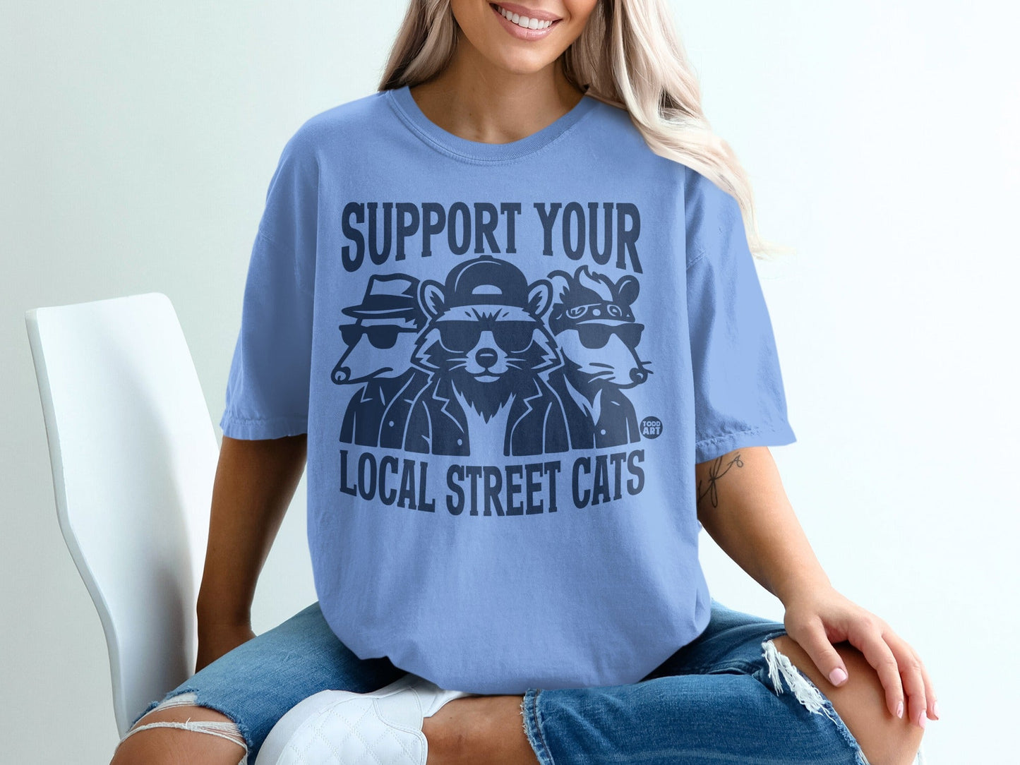 Blue t-shirt with "SUPPORT YOUR LOCAL STREET CATS" text and illustrated cats.