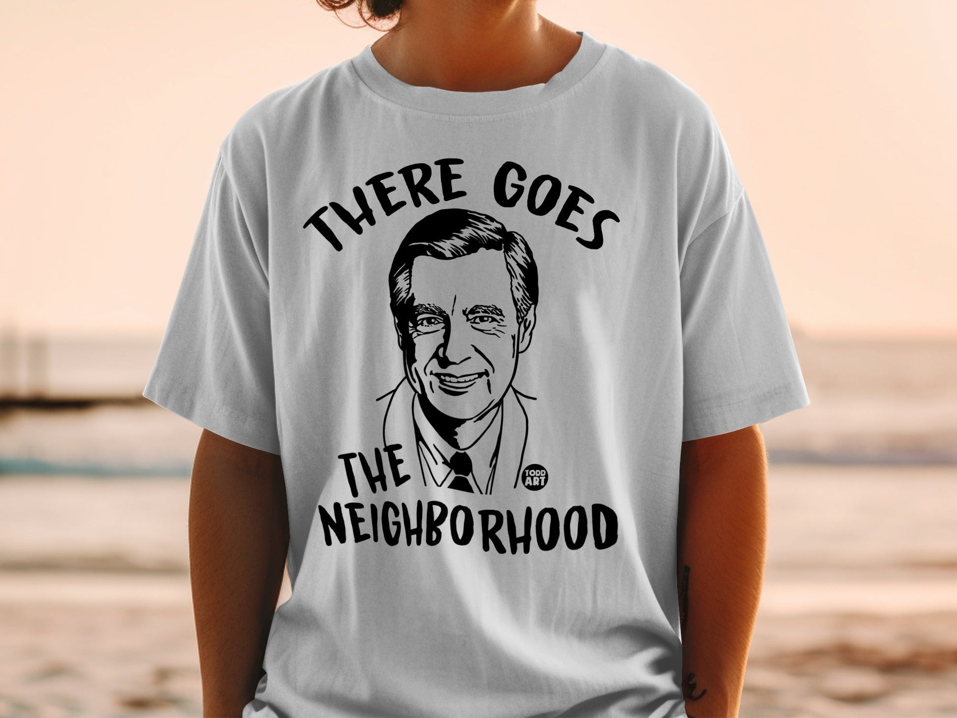 T-shirt with Fred Rogers' portrait and "There Goes The Neighborhood" text.