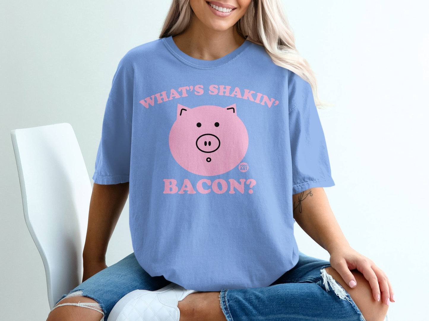 Blue t-shirt with pink pig graphic and text "WHAT'S SHAKIN' BACON?".