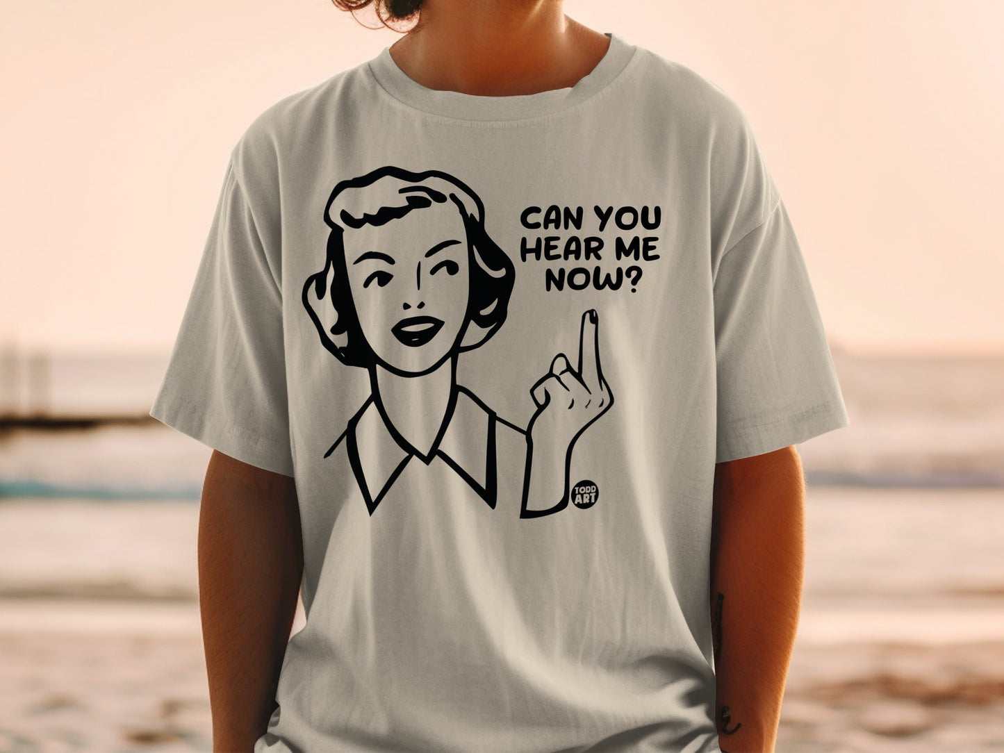 T-shirt with cartoon woman holding up middle finger and text "Can you hear me now?".