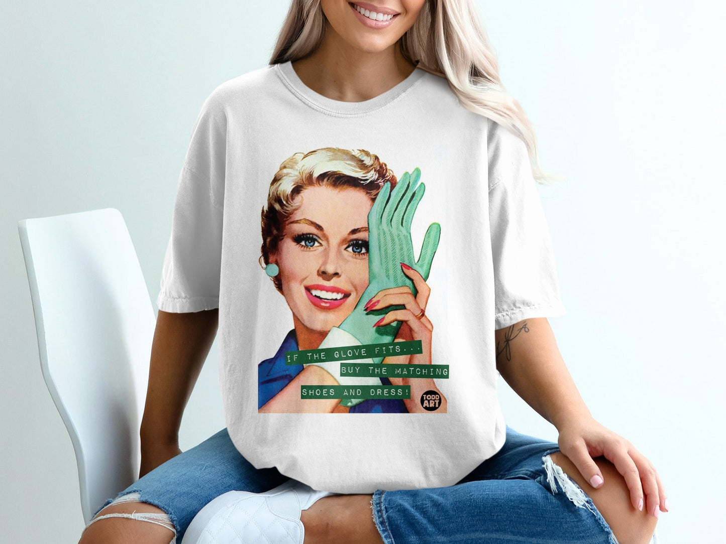 Woman wearing a t-shirt with a retro graphic of a woman holding a glove.