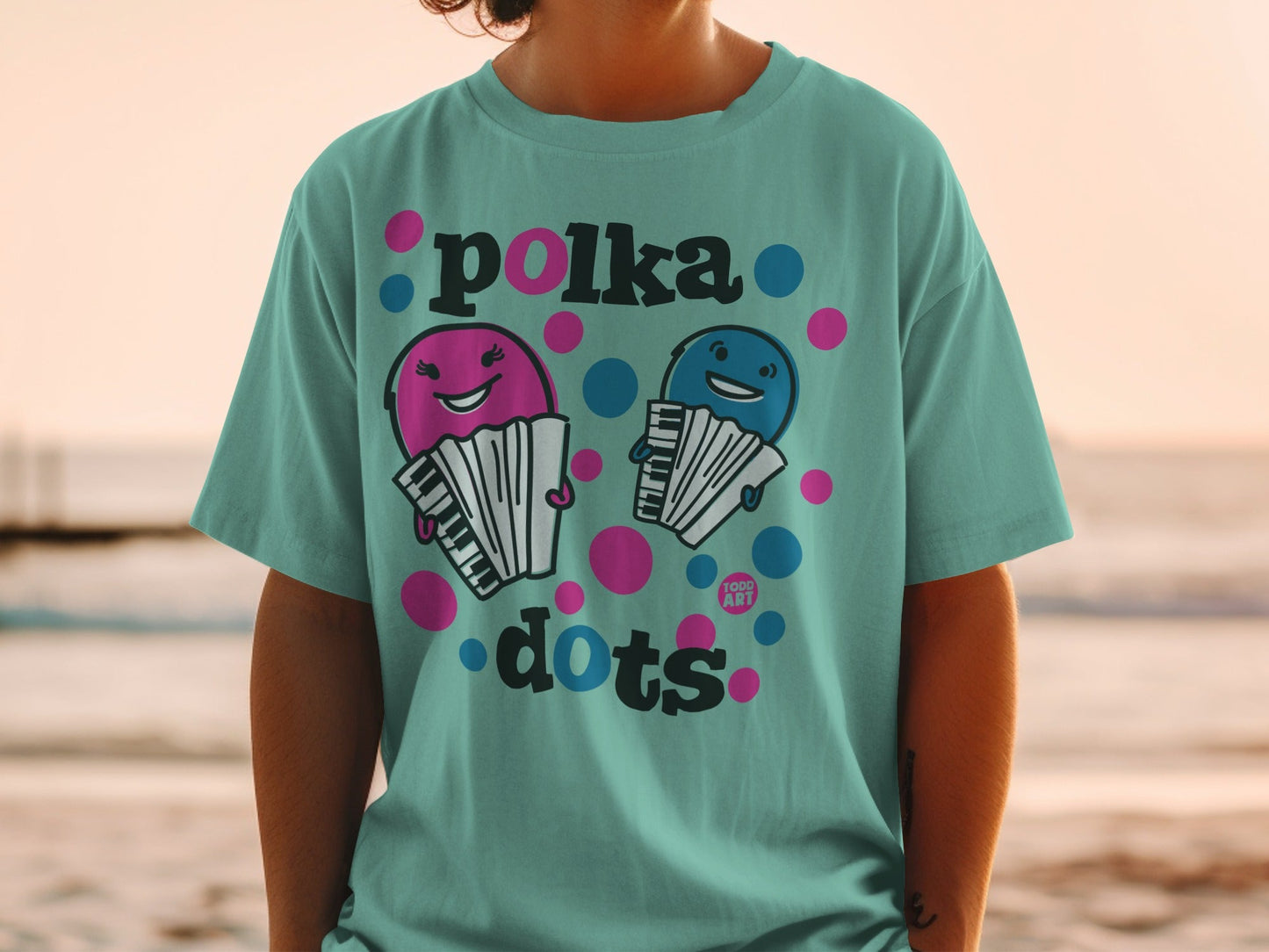 Teal t-shirt with cartoon accordions and "polka dots" text.