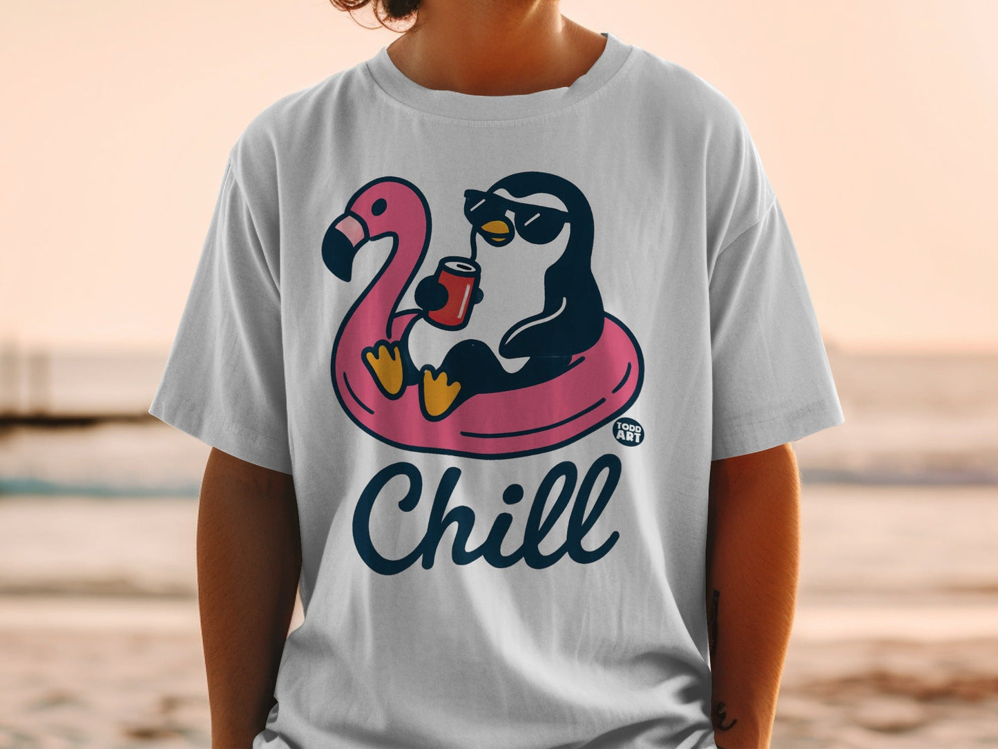 T-shirt with a penguin on a flamingo float and the word "Chill".