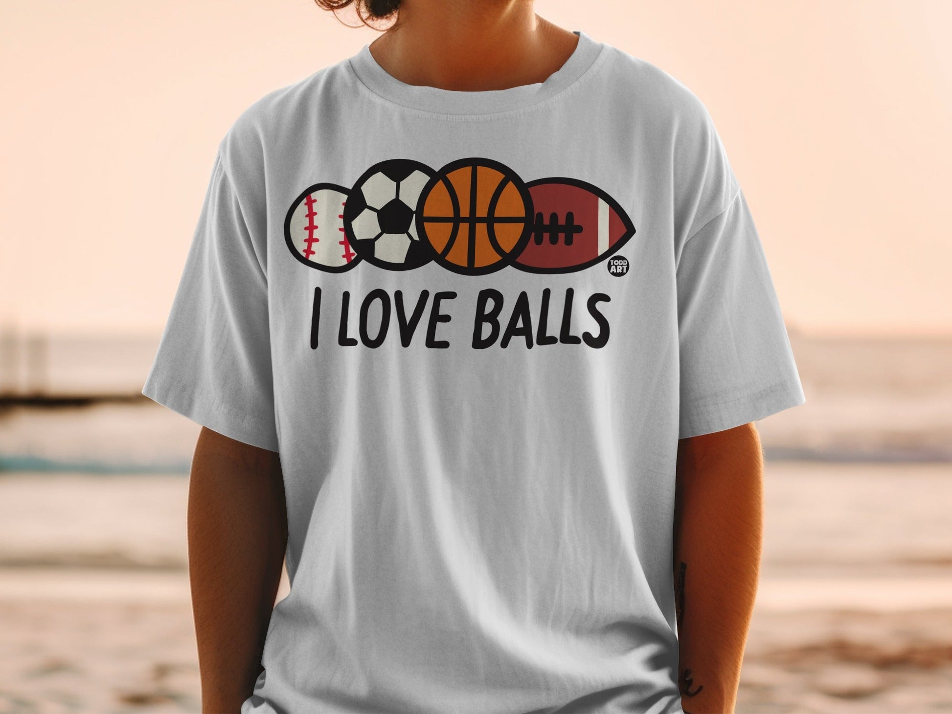 White t-shirt with "I LOVE BALLS" and baseball, basketball, football, and rugby ball graphic.