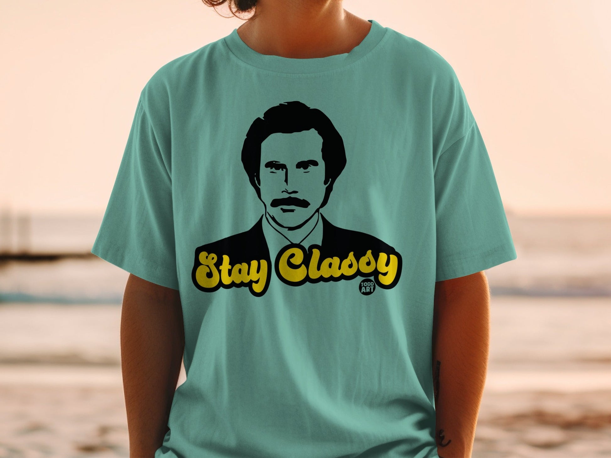 Teal t-shirt with "Stay Classy" text above Ron Burgundy portrait.