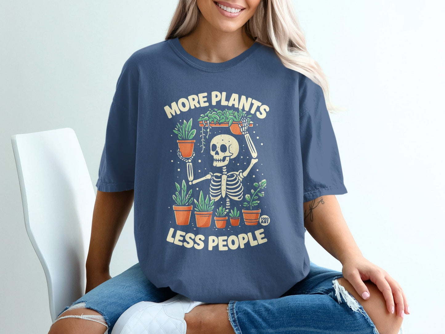 Skeleton wearing t-shirt with "More Plants Less People" text and plant graphics.