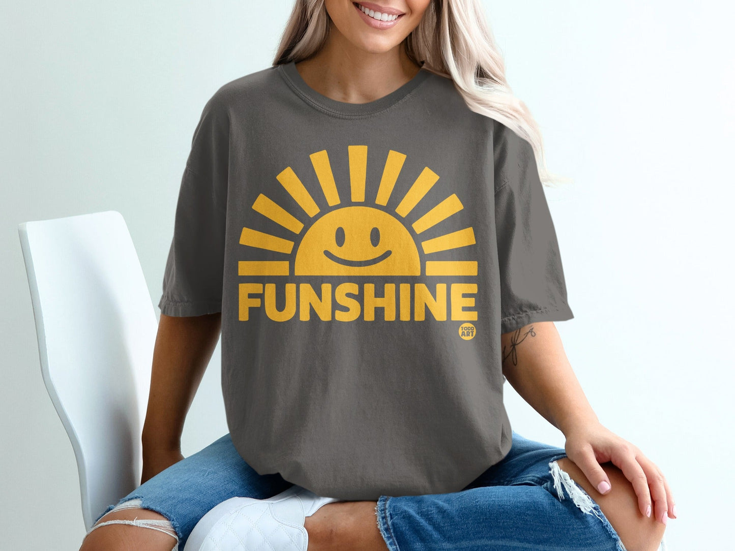 Dark gray t-shirt with a yellow smiling sun graphic and "FUNSHINE" text.