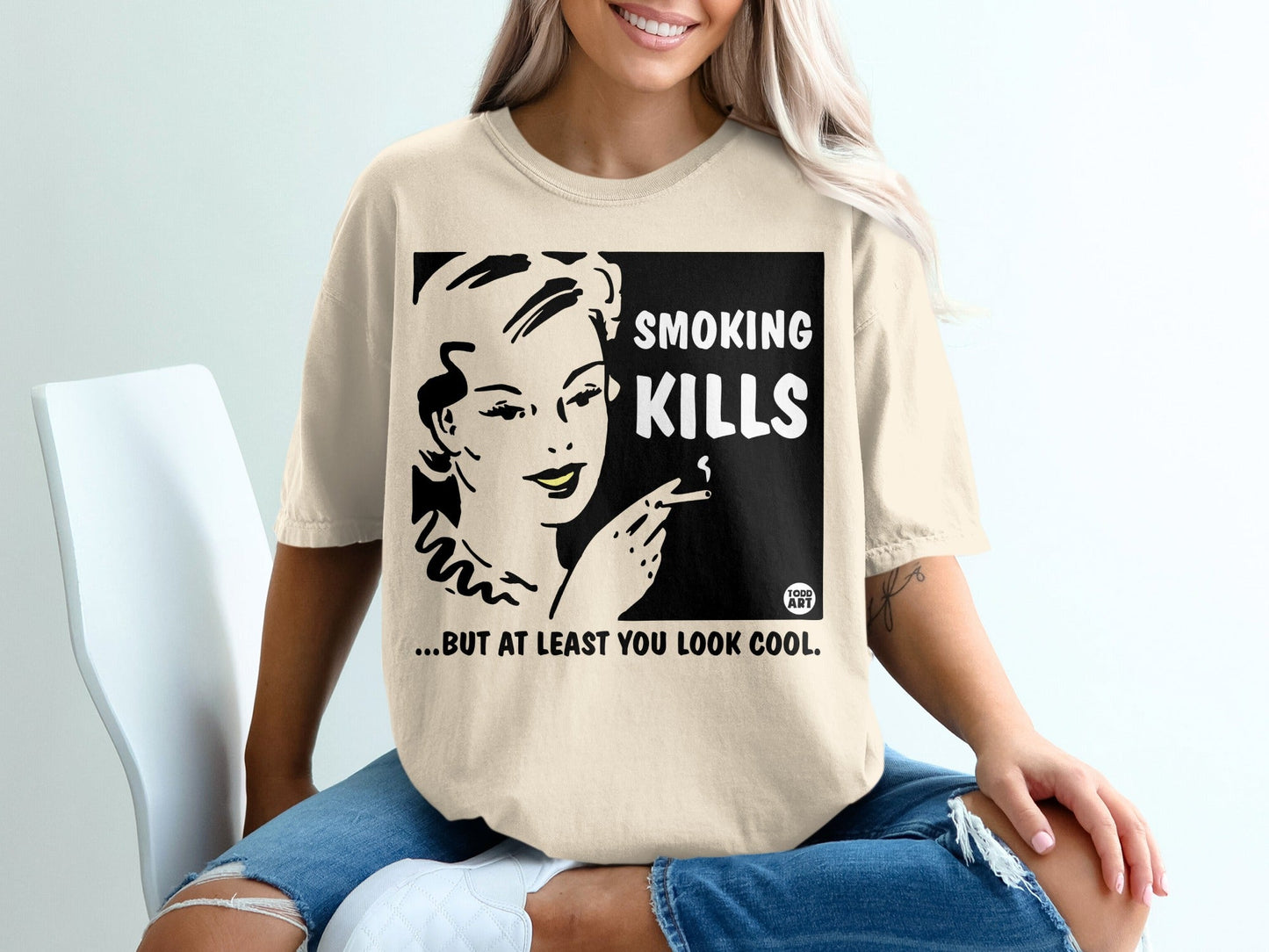 Cream t-shirt with "SMOKING KILLS...BUT AT LEAST YOU LOOK COOL" graphic.