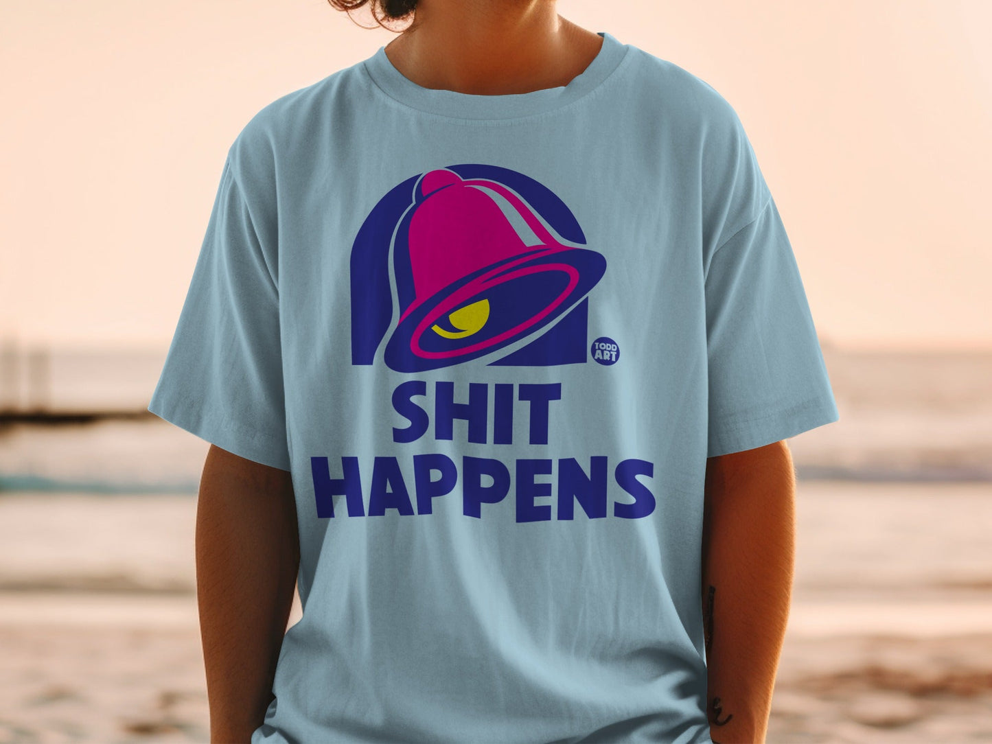 Light blue t-shirt with Taco Bell logo and "SHIT HAPPENS" text.
