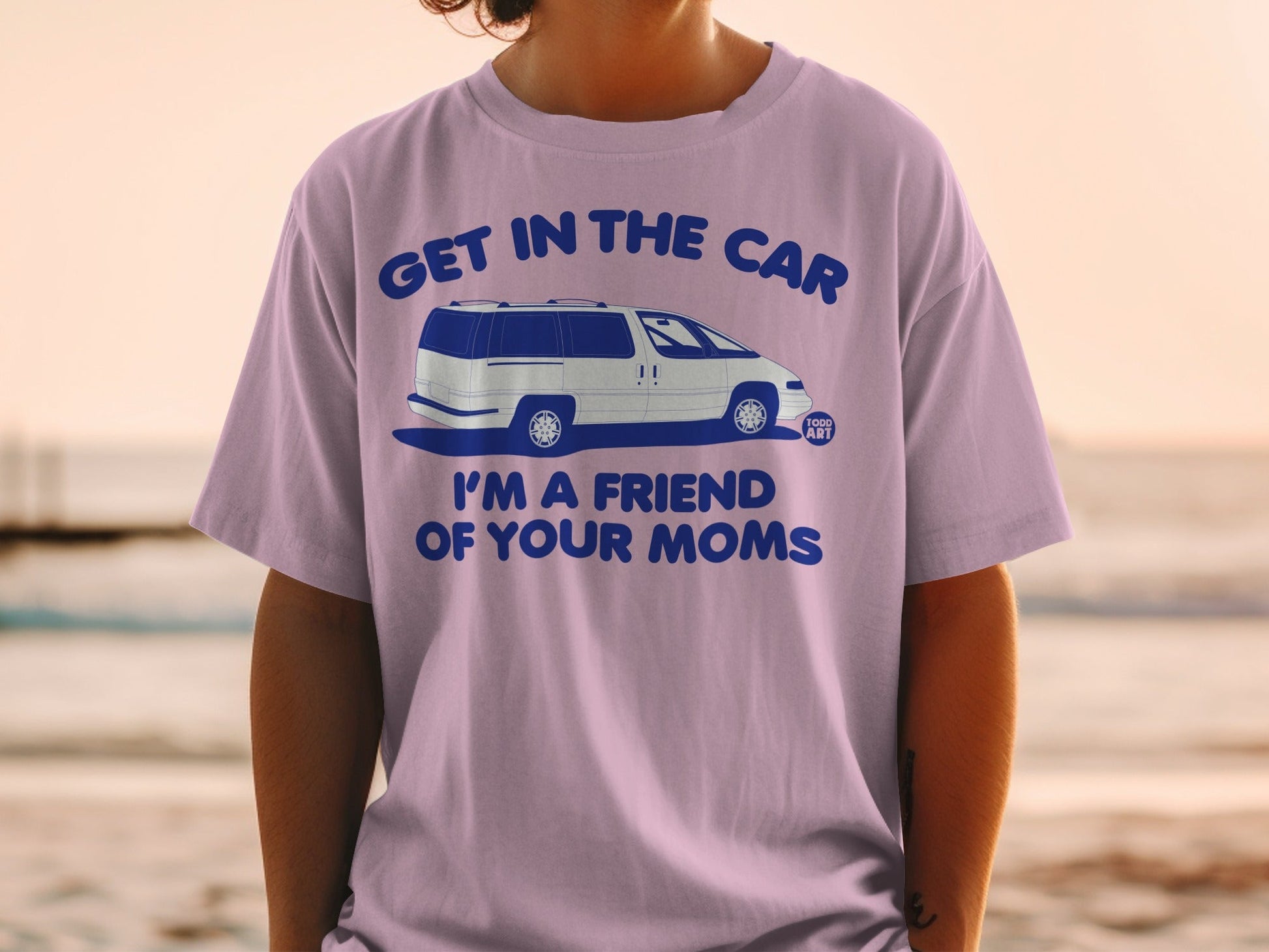 Lavender t-shirt with blue text and illustration of a minivan.