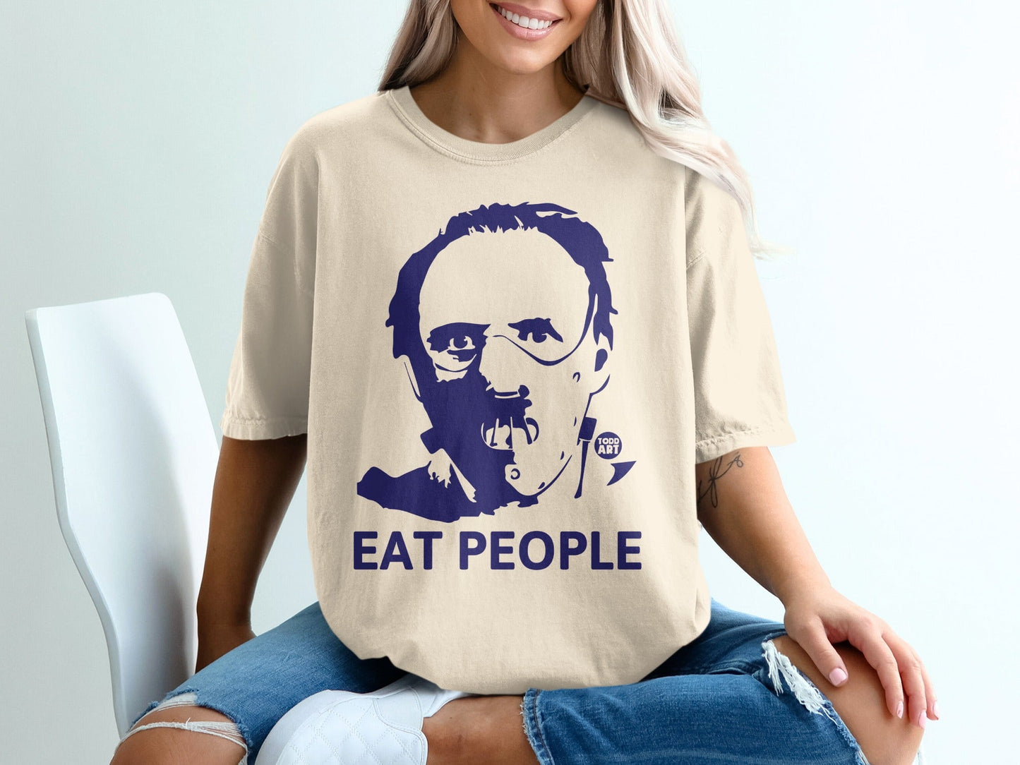 Cream t-shirt with dark blue graphic of Hannibal Lecter and the text "EAT PEOPLE".