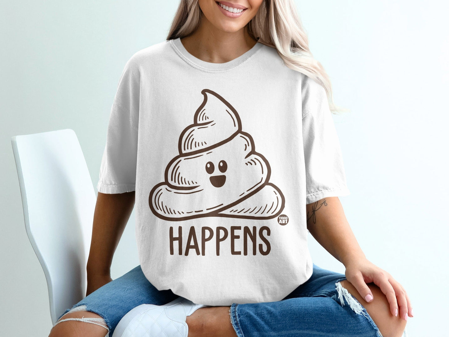 White t-shirt with a smiling poop emoji and the word "HAPPENS".