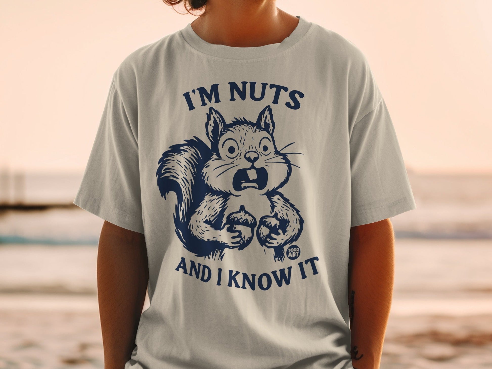 Blue graphic t-shirt with shocked squirrel and text "I'M NUTS AND I KNOW IT".