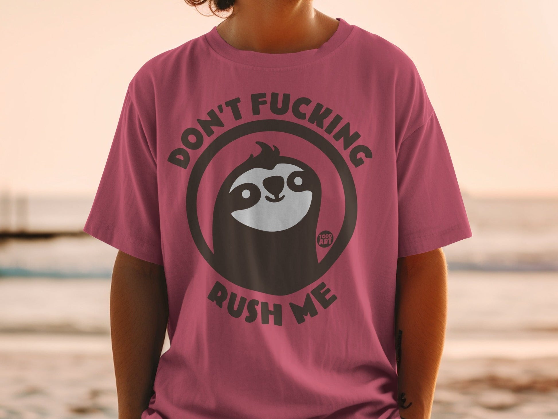 Sloth wearing sunglasses on pink t-shirt, "Don't Fucking Rush Me" text.