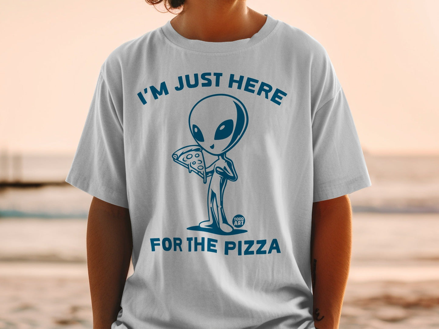Blue graphic of an alien holding pizza with text "I'M JUST HERE FOR THE PIZZA".