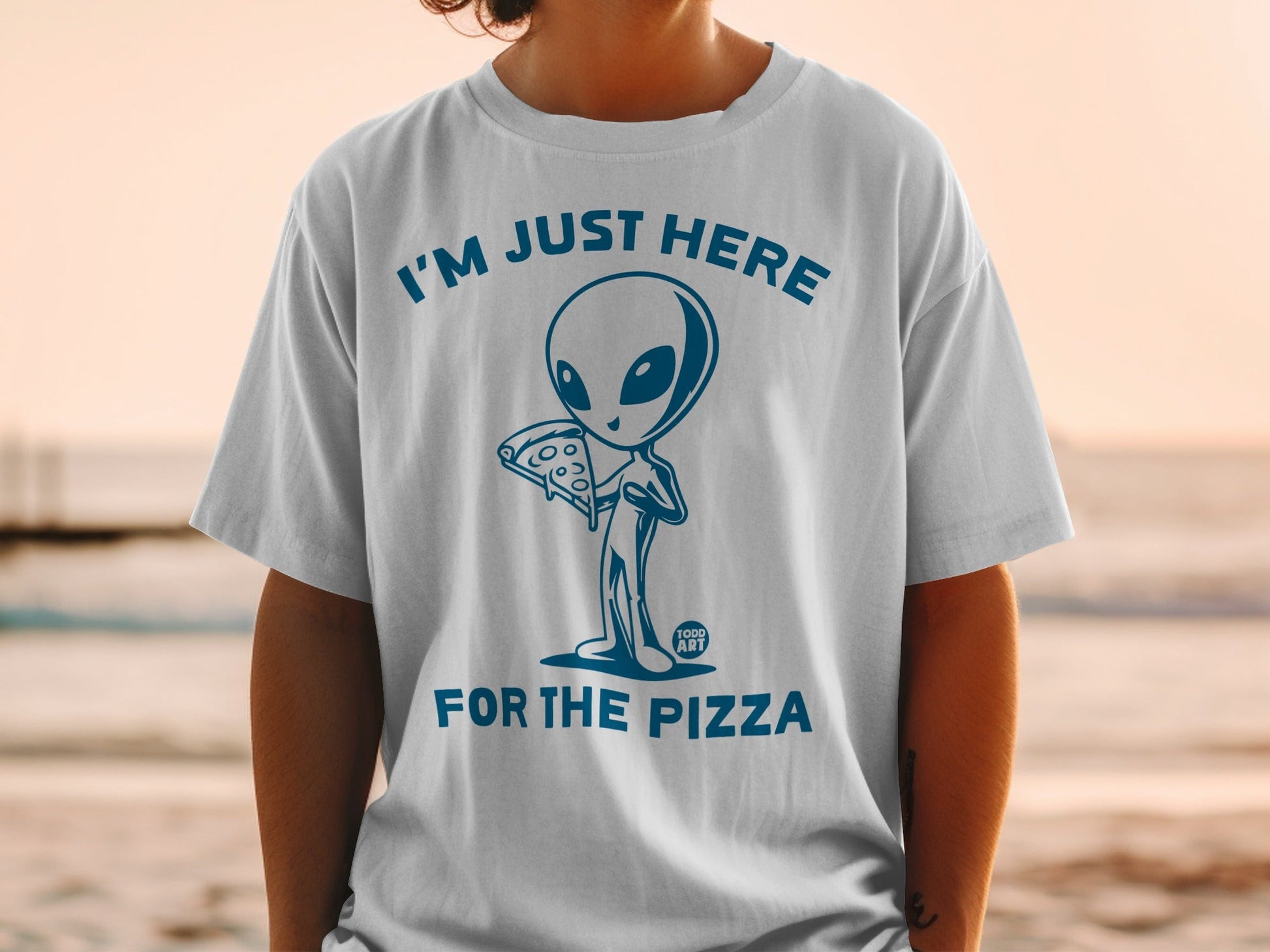 Blue graphic of an alien holding pizza with text "I'M JUST HERE FOR THE PIZZA".