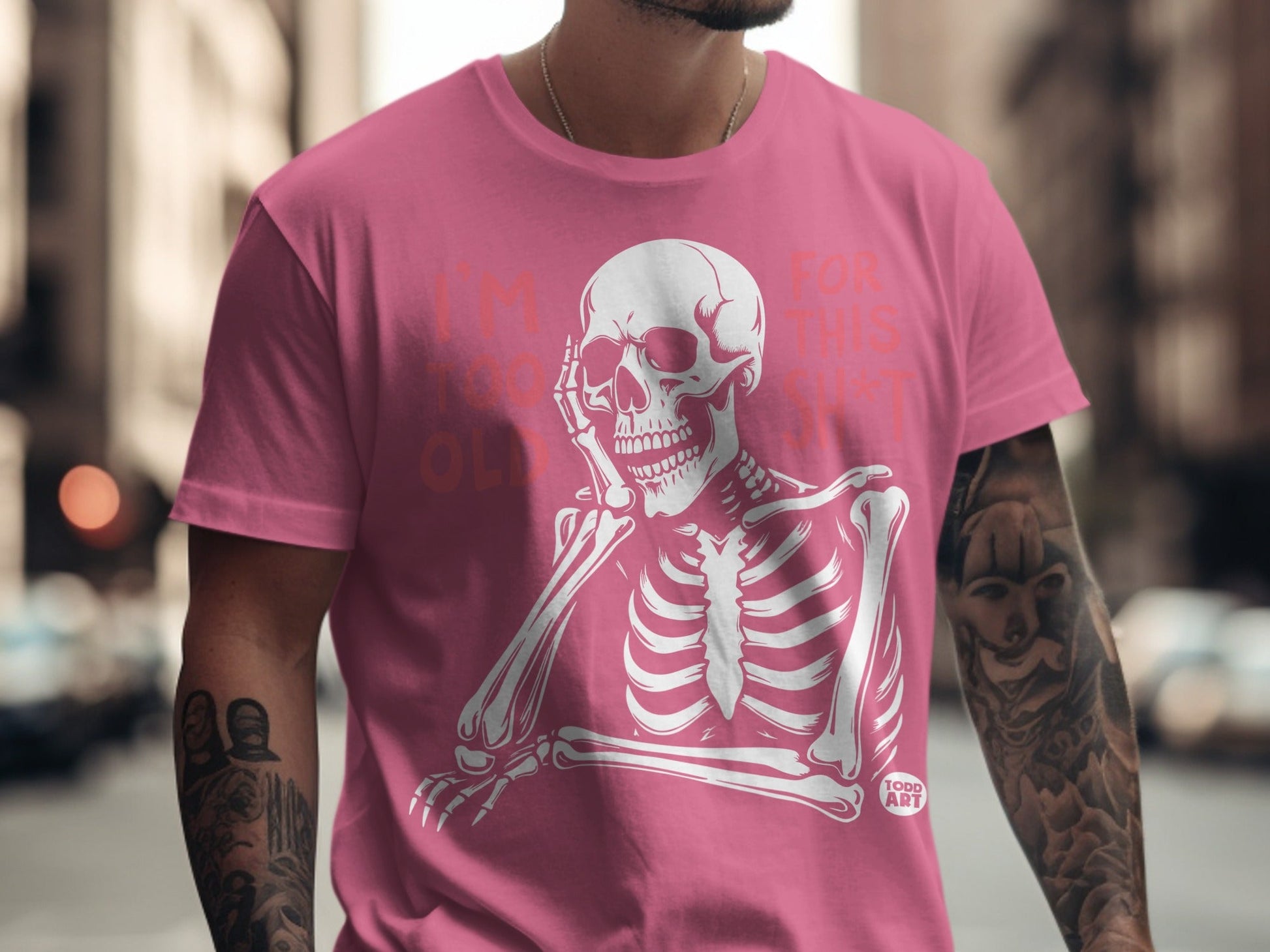 Pink t-shirt with white skeleton graphic and text "I'M TOO OLD FOR THIS SHIT".