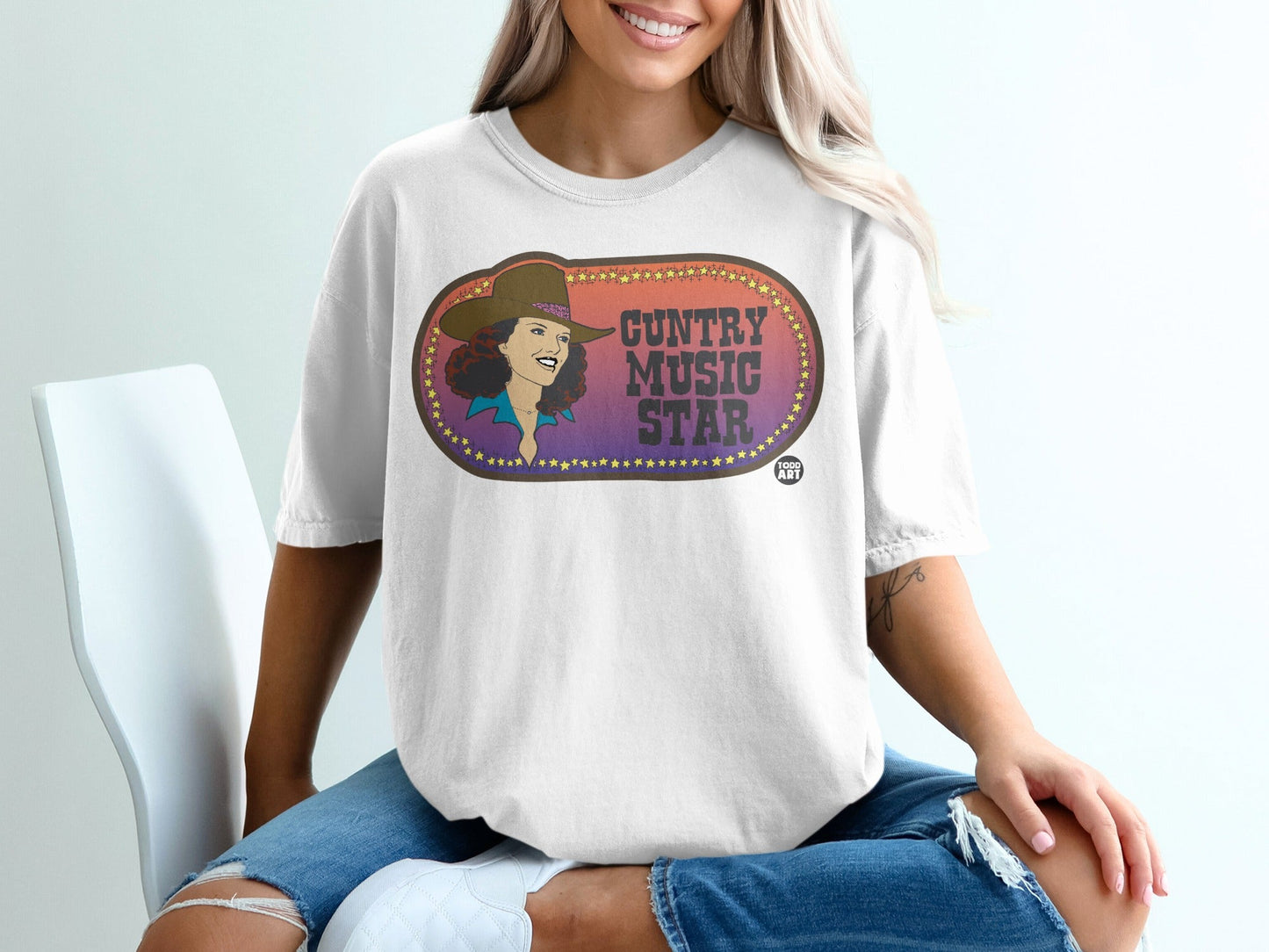 Country Music Star graphic on a white t-shirt with a woman wearing it.