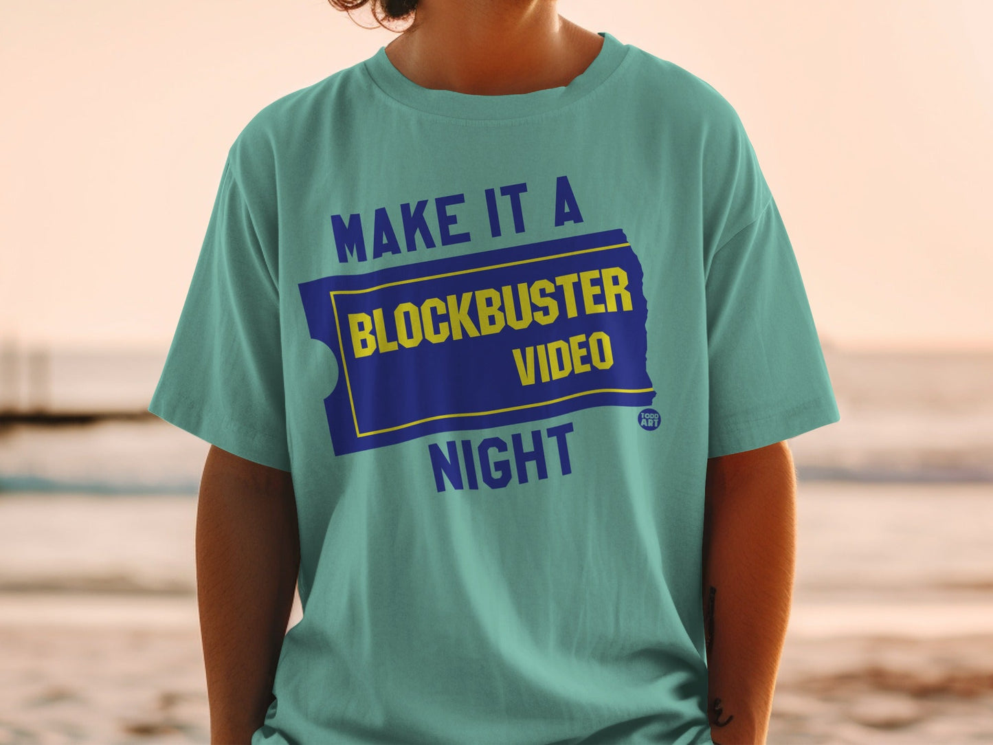 Teal t-shirt with "Make it a Blockbuster Night" and Blockbuster logo.