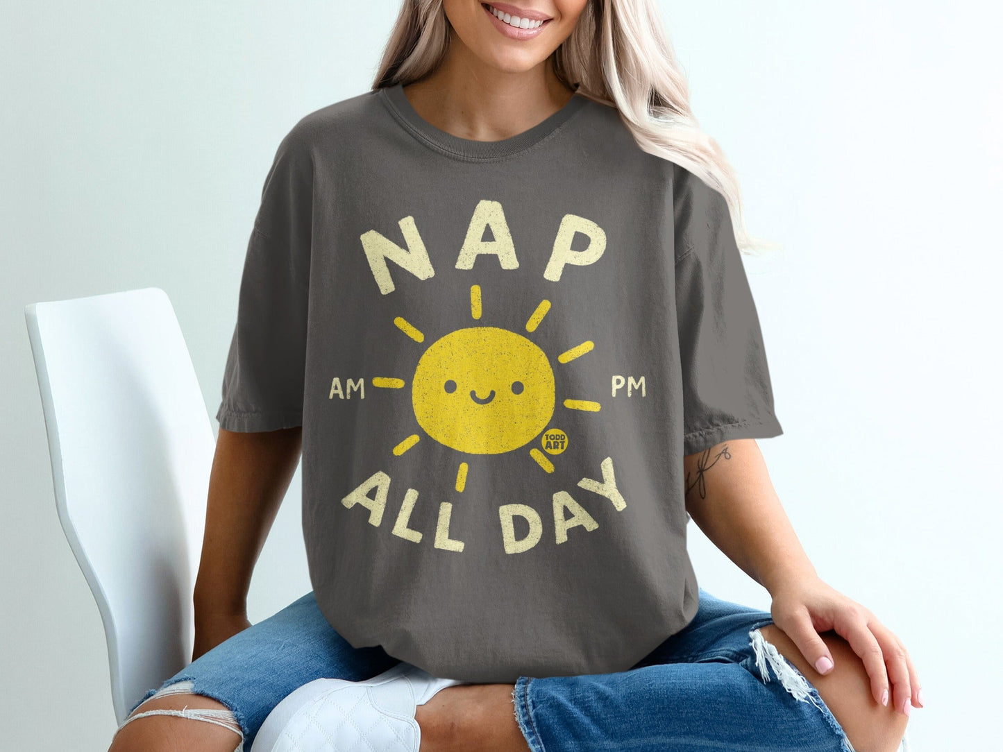 Dark gray t-shirt with "NAP ALL DAY" and smiling sun graphic.