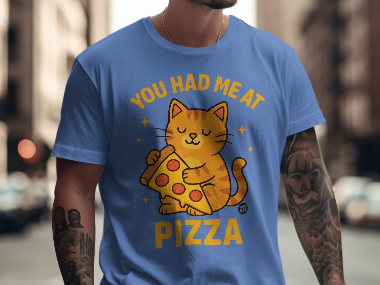 Blue t-shirt with a cartoon cat holding a slice of pizza and text "You had me at pizza".